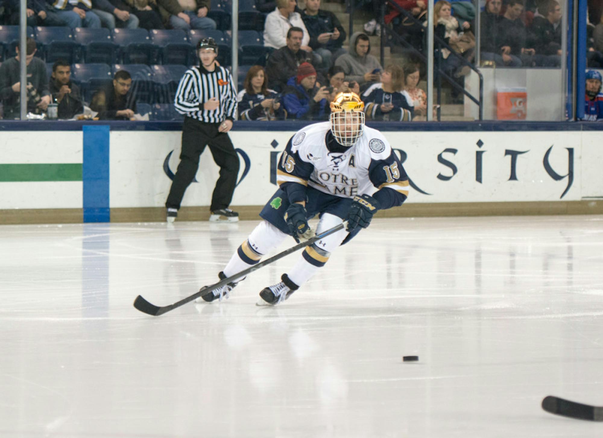 Irish senior right winger Peter Schneider skates after a loose puck during Notre Dame’s 2-2 tie with UMass-Lowell on Nov. 21.