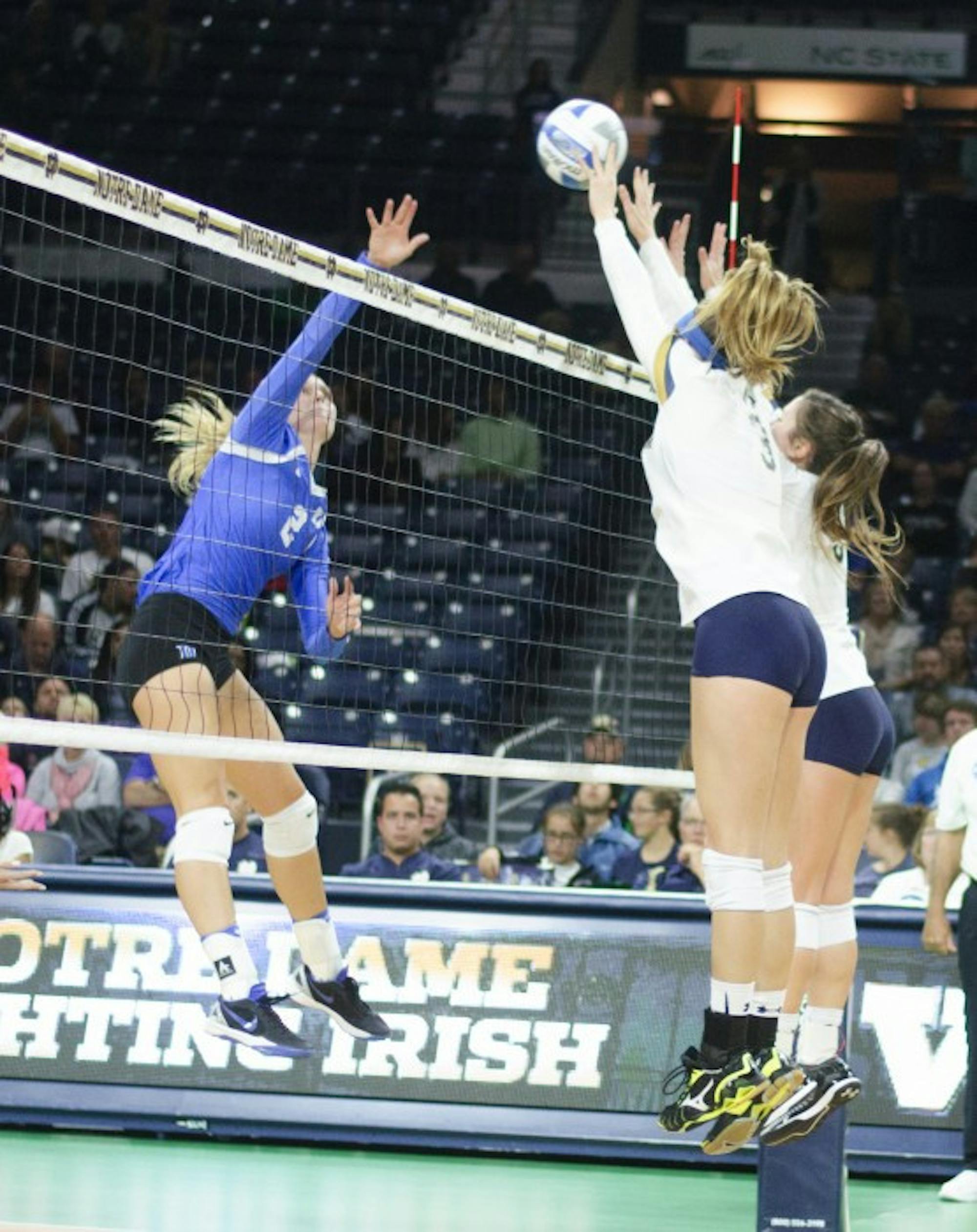 Irish junior middle blocker Sam Fry, left, and sophomore outside hitter Rebecca Nunge go up for a block during Notre Dame's 3-1 win over Duke on Sept. 30 at Purcell Pavilion.