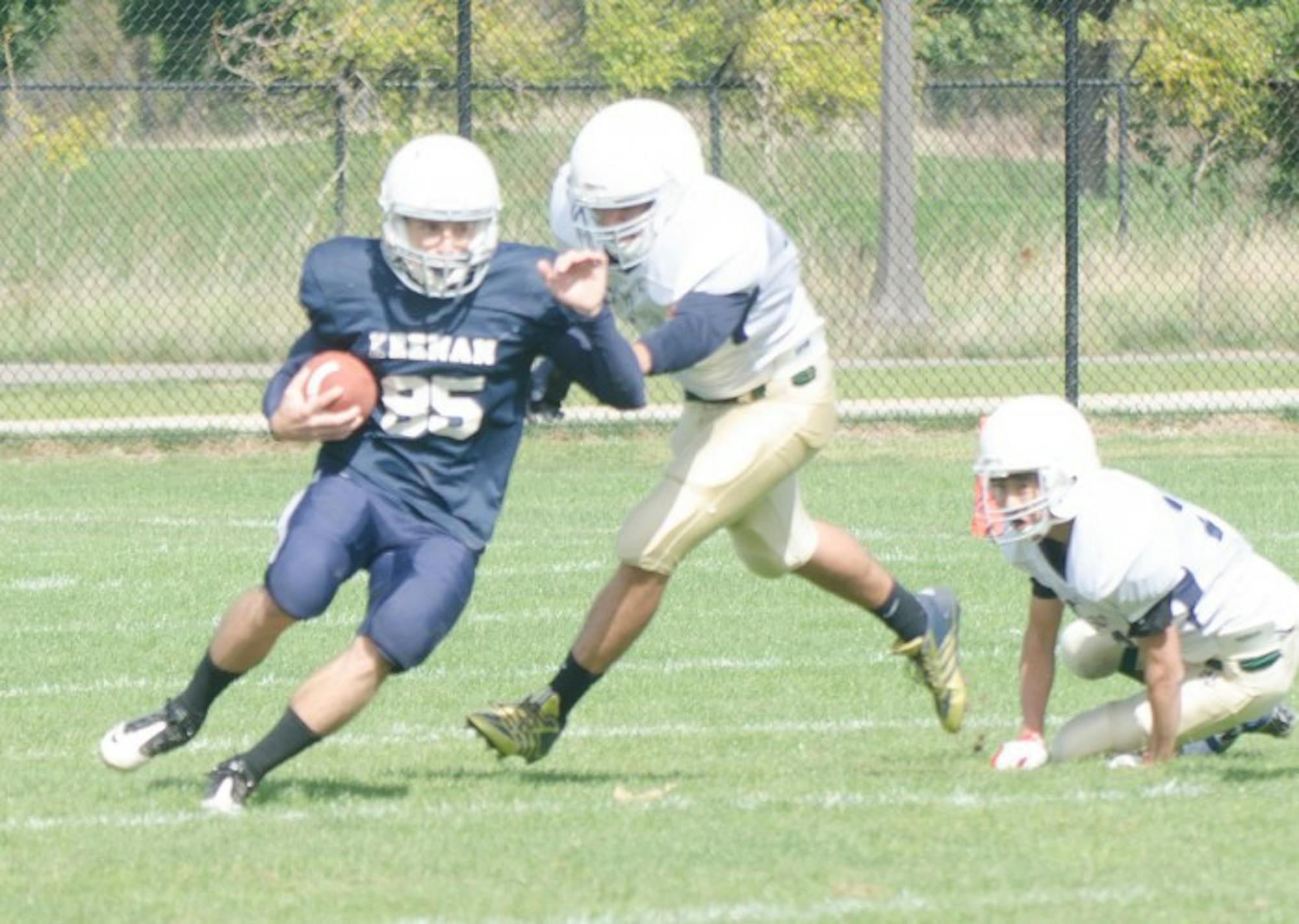 A Keenan running back rushes past O’Neill defenders in a 20-0 win for the Knights on Oct. 5.