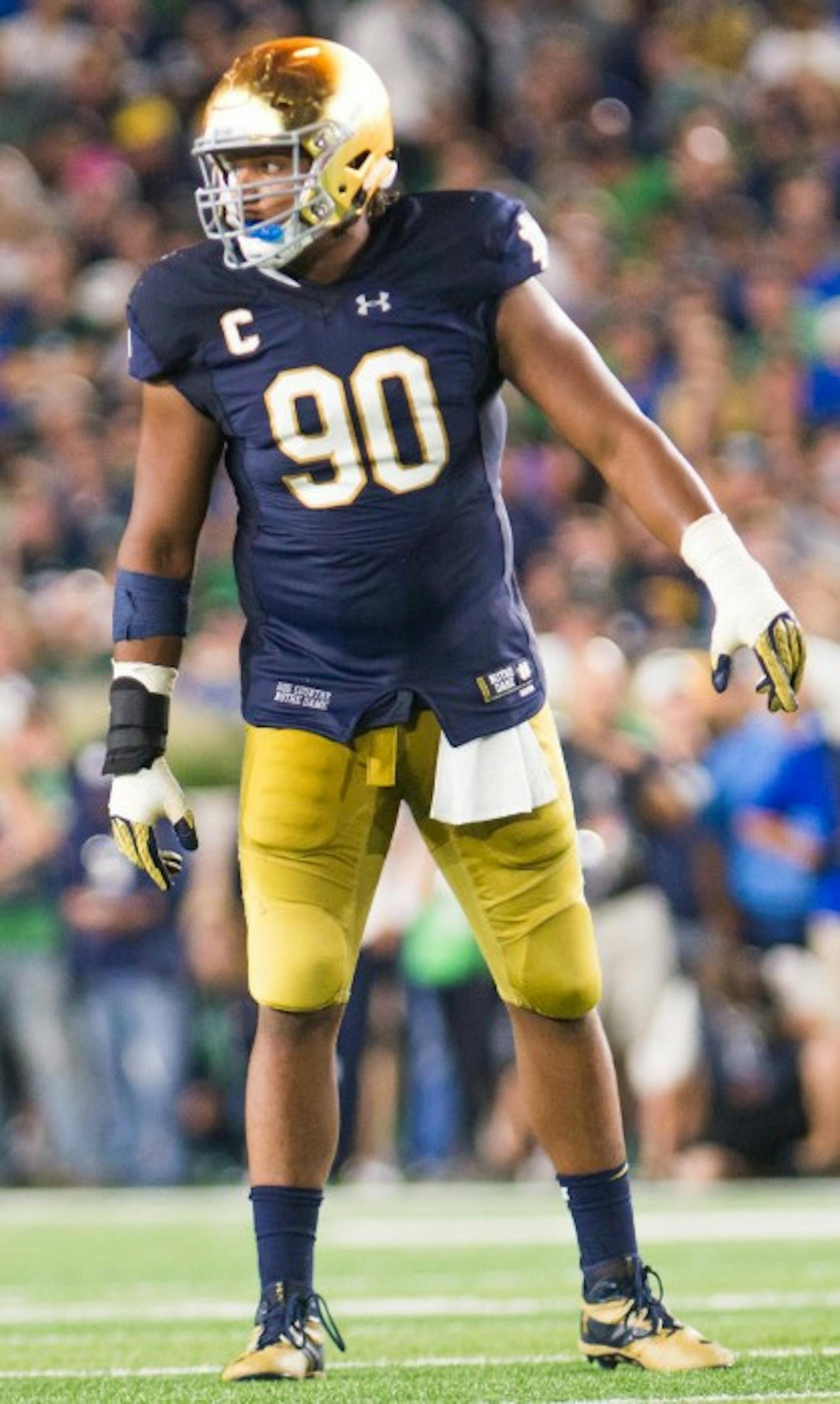 Irish senior defensive lineman Isaac Rochell prepares for a play during Notre Dame’s 36-28 loss against Michigan State. Rochell, one of Notre Dame’s four captains, leads a defensive unit without a sack in 2016.