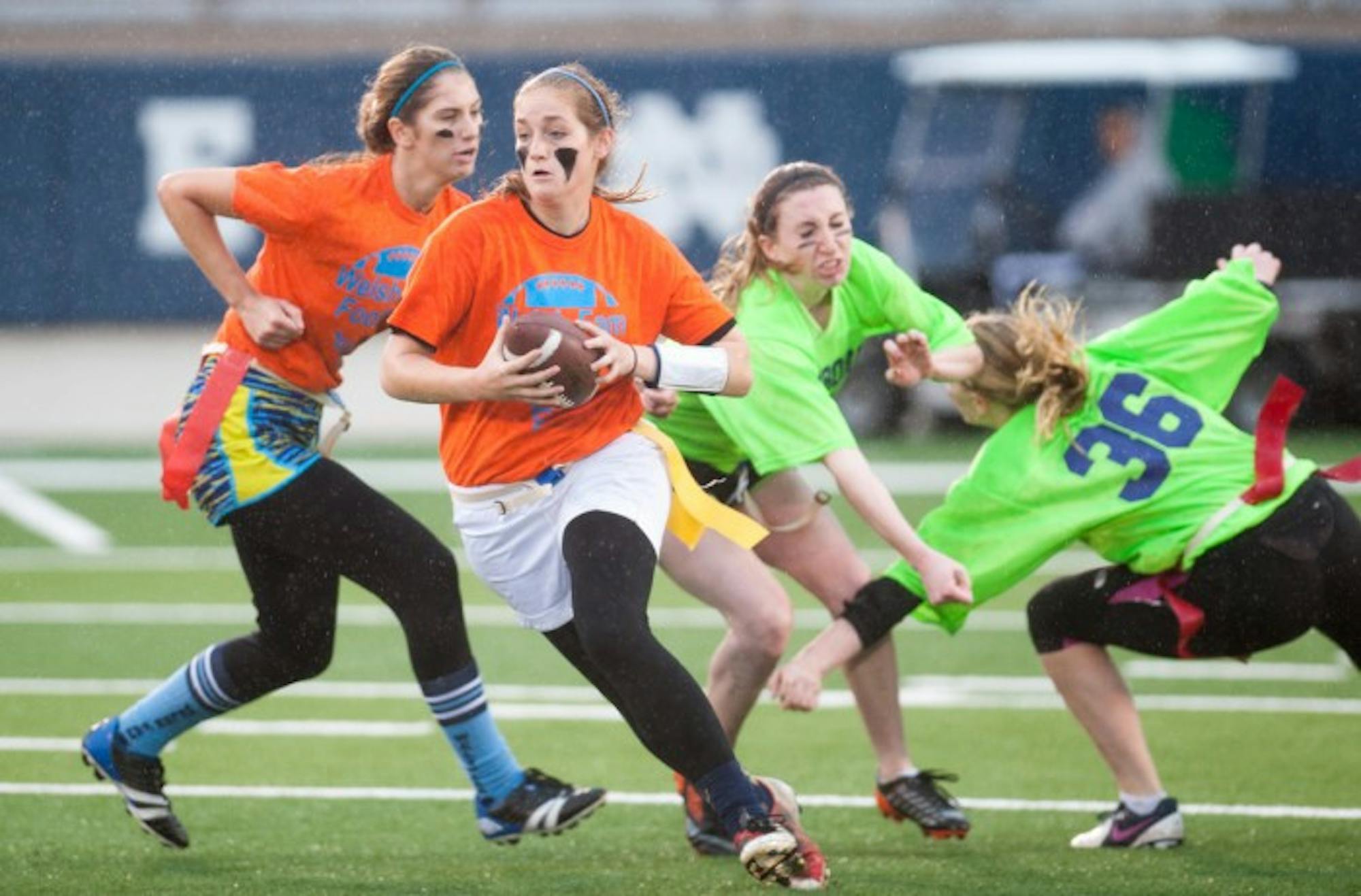 A student representing Welsh Family Hall evades a defender from Pangborn Hall during a women's interhall flag football championship in Notre Dame Stadium in Nov. 2014.