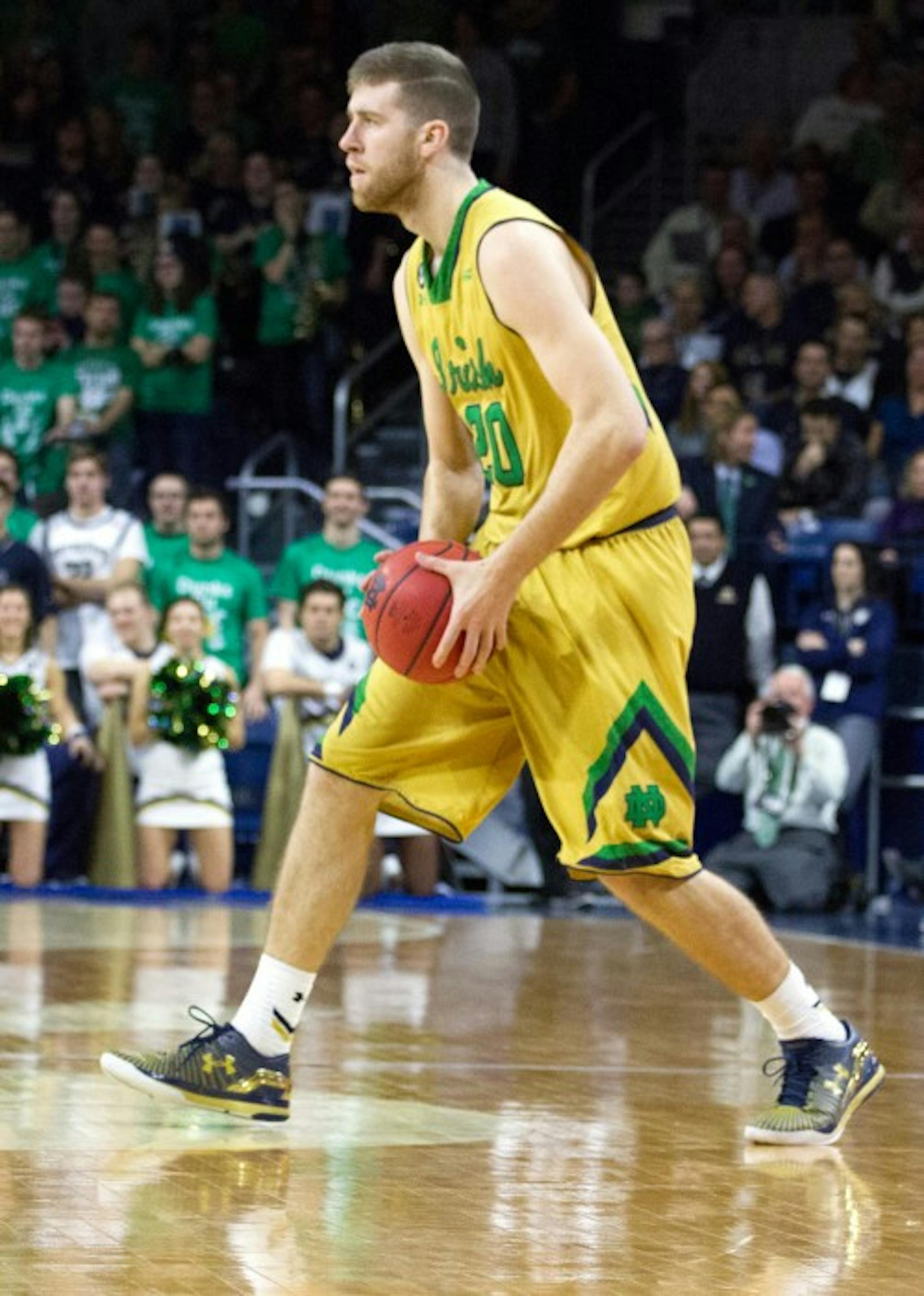 Irish senior forward A.J. Burgett looks to pass during Notre Dame’s 76-49 win over Boston College at Purcell Pavilion on Jan. 23. In his first start in nearly two years, Burgett scored 14 points Sunday.