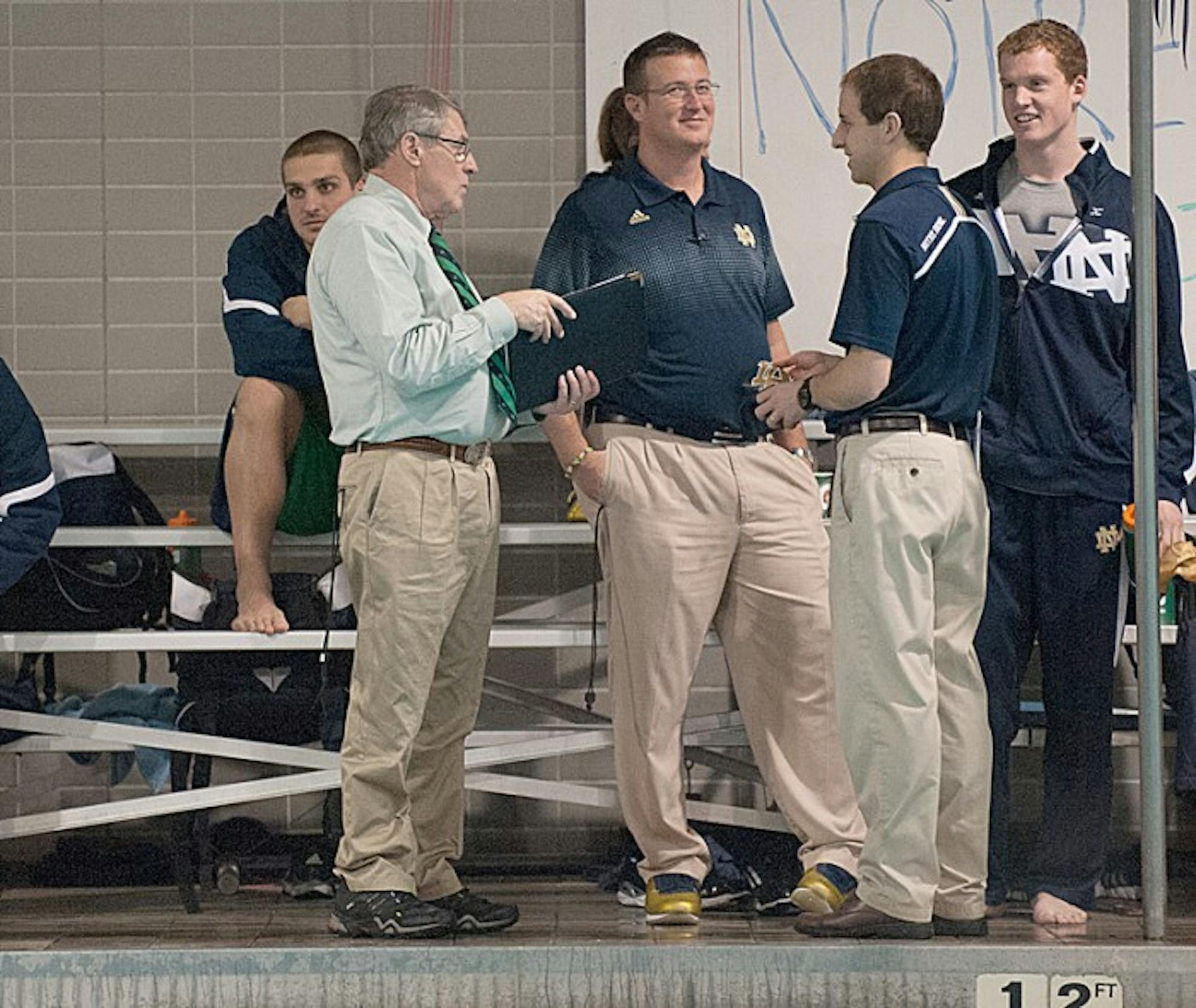 Irish coach Tim Welsh, far left, talks over his team’s win Saturday against Cleveland State, which was his last home meet as head coach.