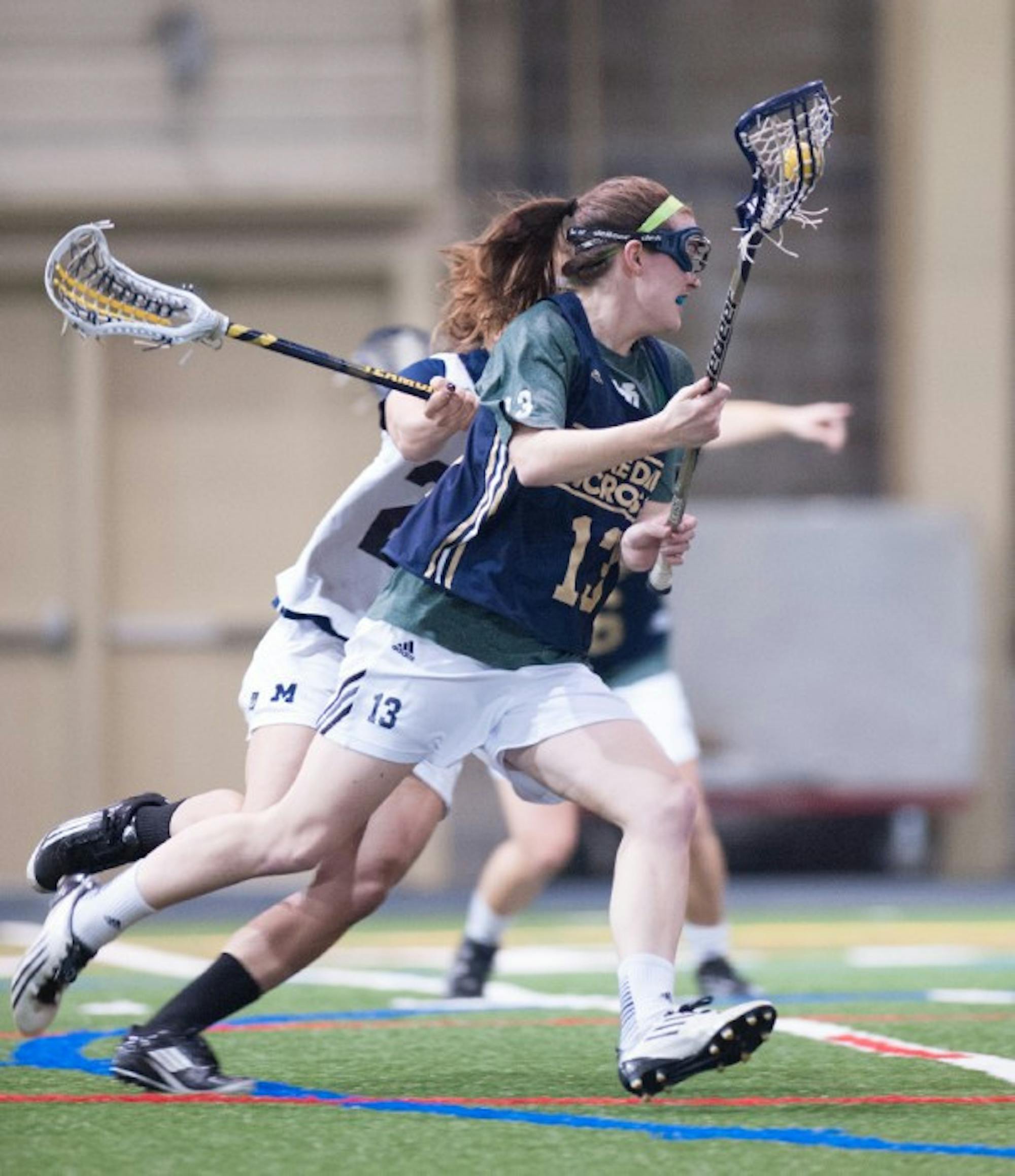 Notre Dame junior midfielder Caitlin Gargan carries the ball for Notre Dame while she looks to score during Notre Dame's 19-7 scrimmage win over Michigan on Saturday. Gargan returns as one of the last season's top scorers, as she finished 2013 with 19 goals and five assists for the Irish.