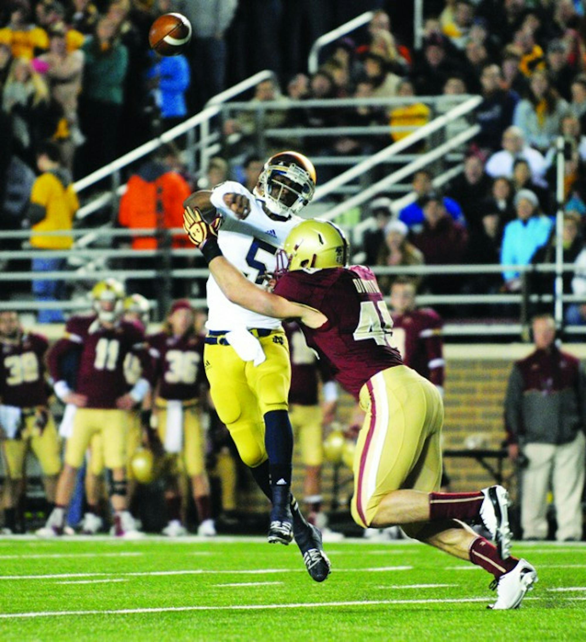 Former Irish quarterback Everett Golson is hit by a Boston College defender as he throws during Notre Dame’s 21-6 win at Alumni Stadium in Boston on Nov. 10, 2012.
