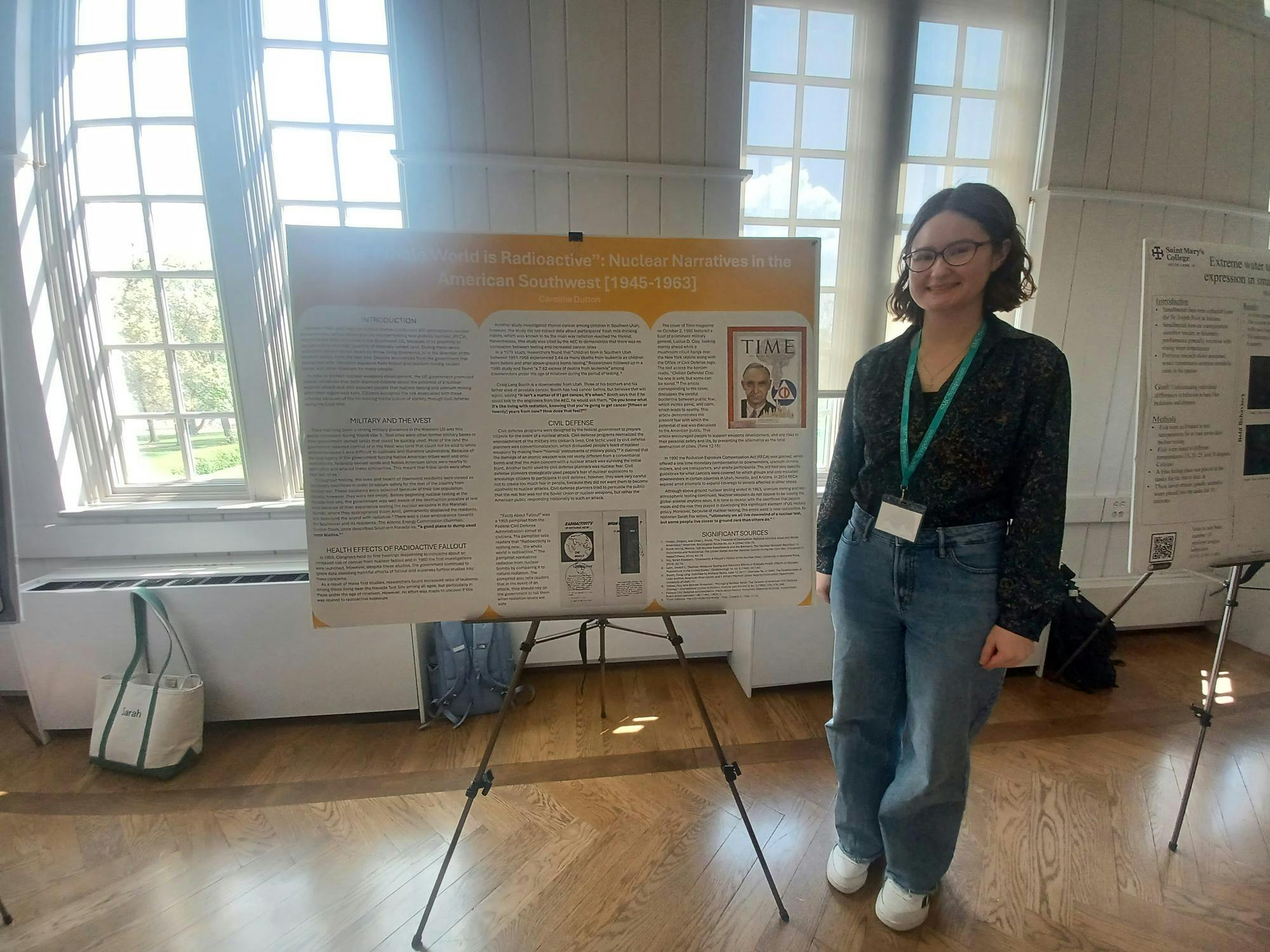 Senior Caroline Dutton stands next to research project on nuclear projects.jpg