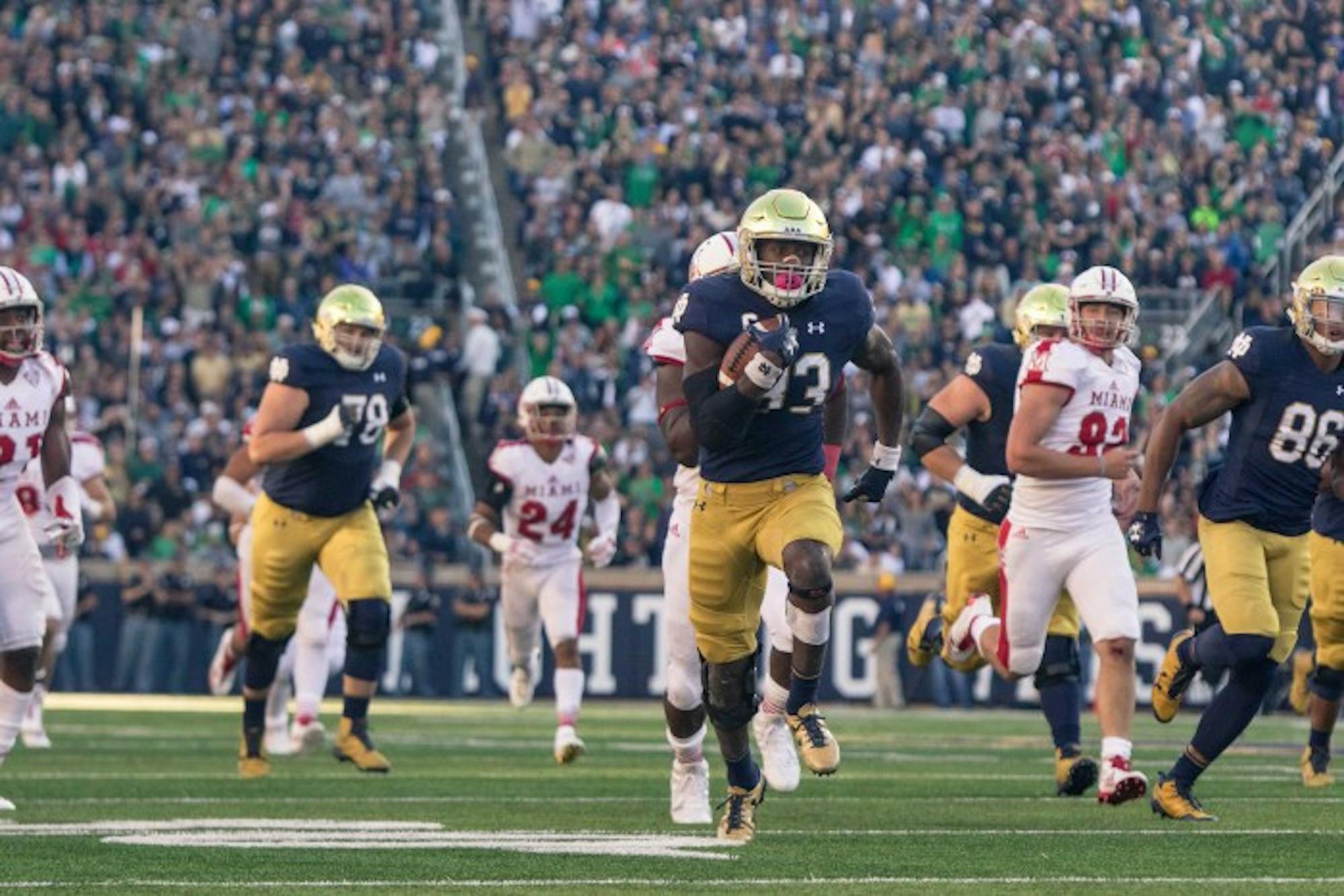 Irish junior running back Josh Adams breaks away from the back for a touchdown run during Notre Dame’s 52-17 win over Miami (OH) on Saturday at Notre Dame Stadium.