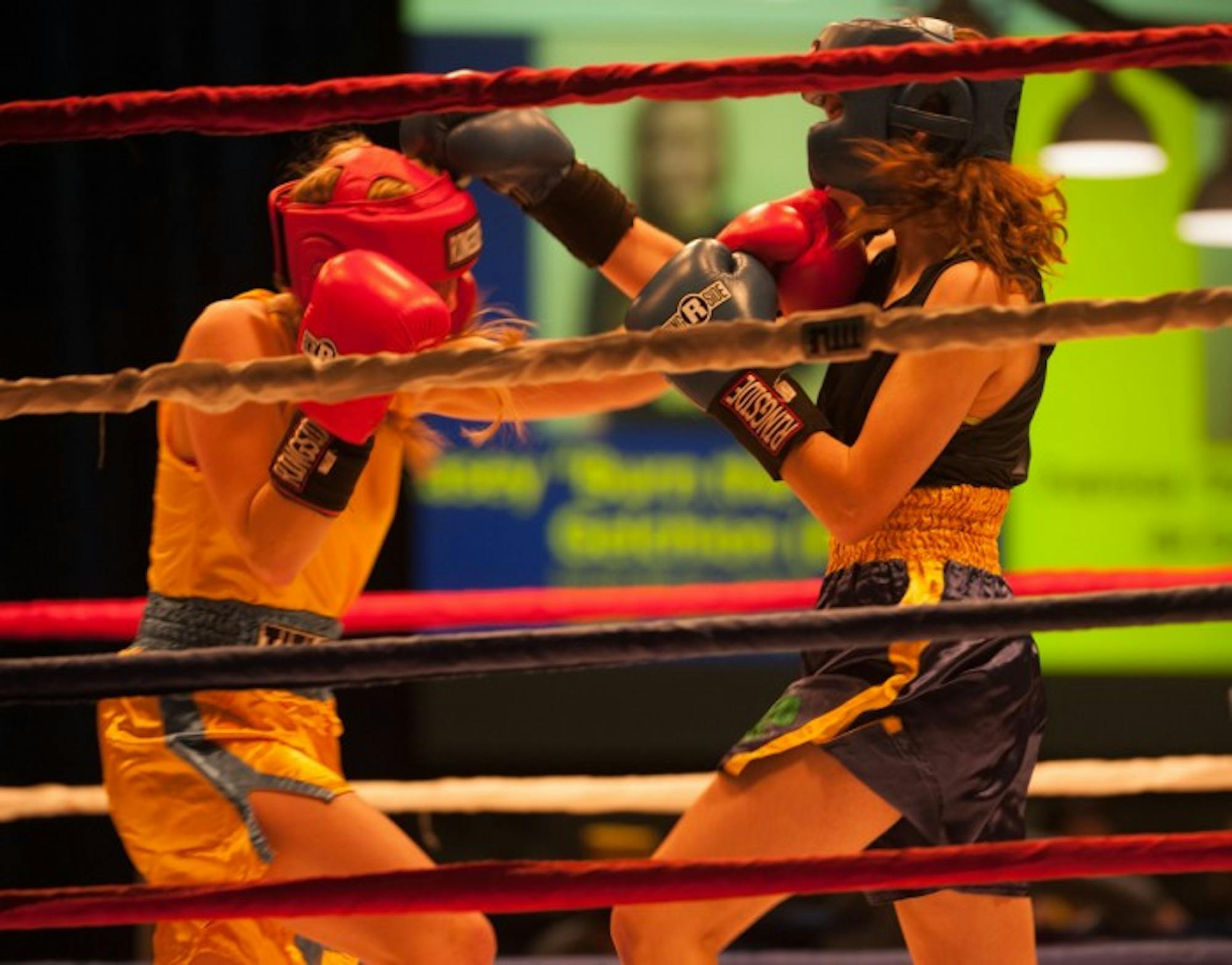 Junior Kelly Smith and sophomore Meg Hunt exchange punches  during Sunday’s semifinal round of Baraka Bouts.