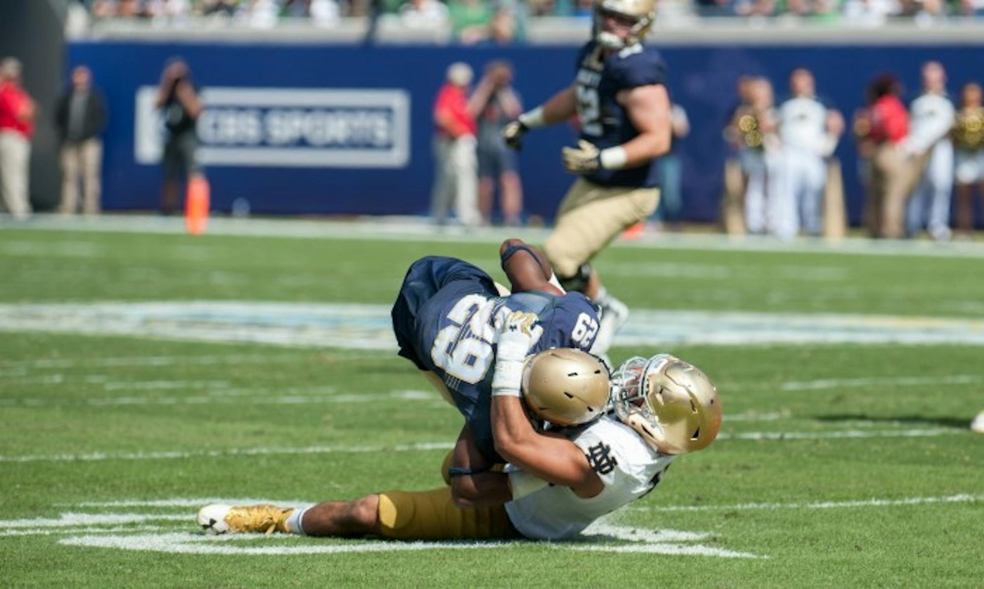 Irish junior Greer Martini tackles the Navy ball carrier behind the line of scrimmage during Notre Dame's 28-27 loss to Navy on Saturday. Martini had 11 total tackles in the game.