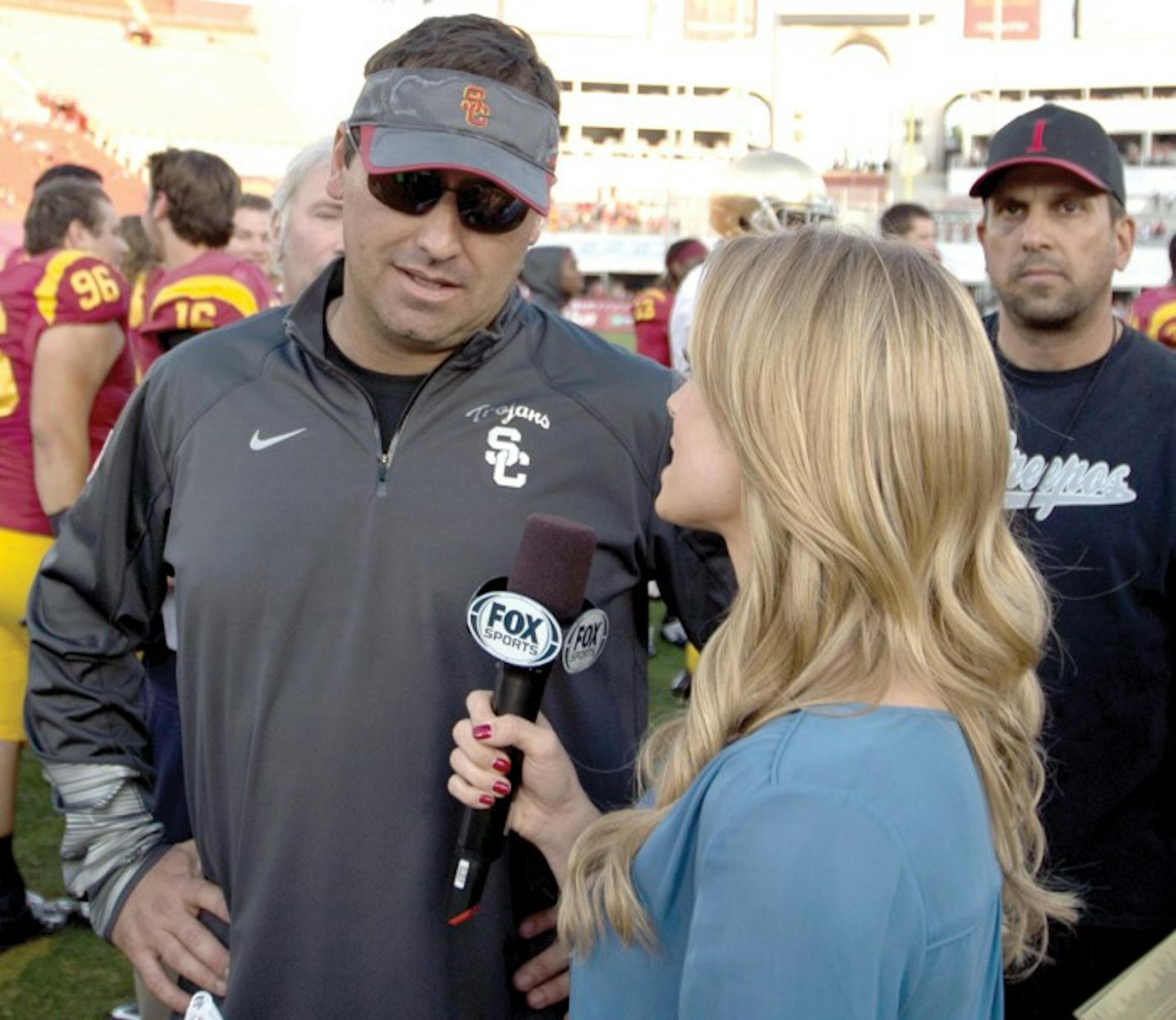 Former USC head coach Steve Sarkisian chats with a reporter following the Trojans’ win over Notre Dame last year in Los Angeles. Sarkisian was fired Monday by USC athletic director Pat Haden.