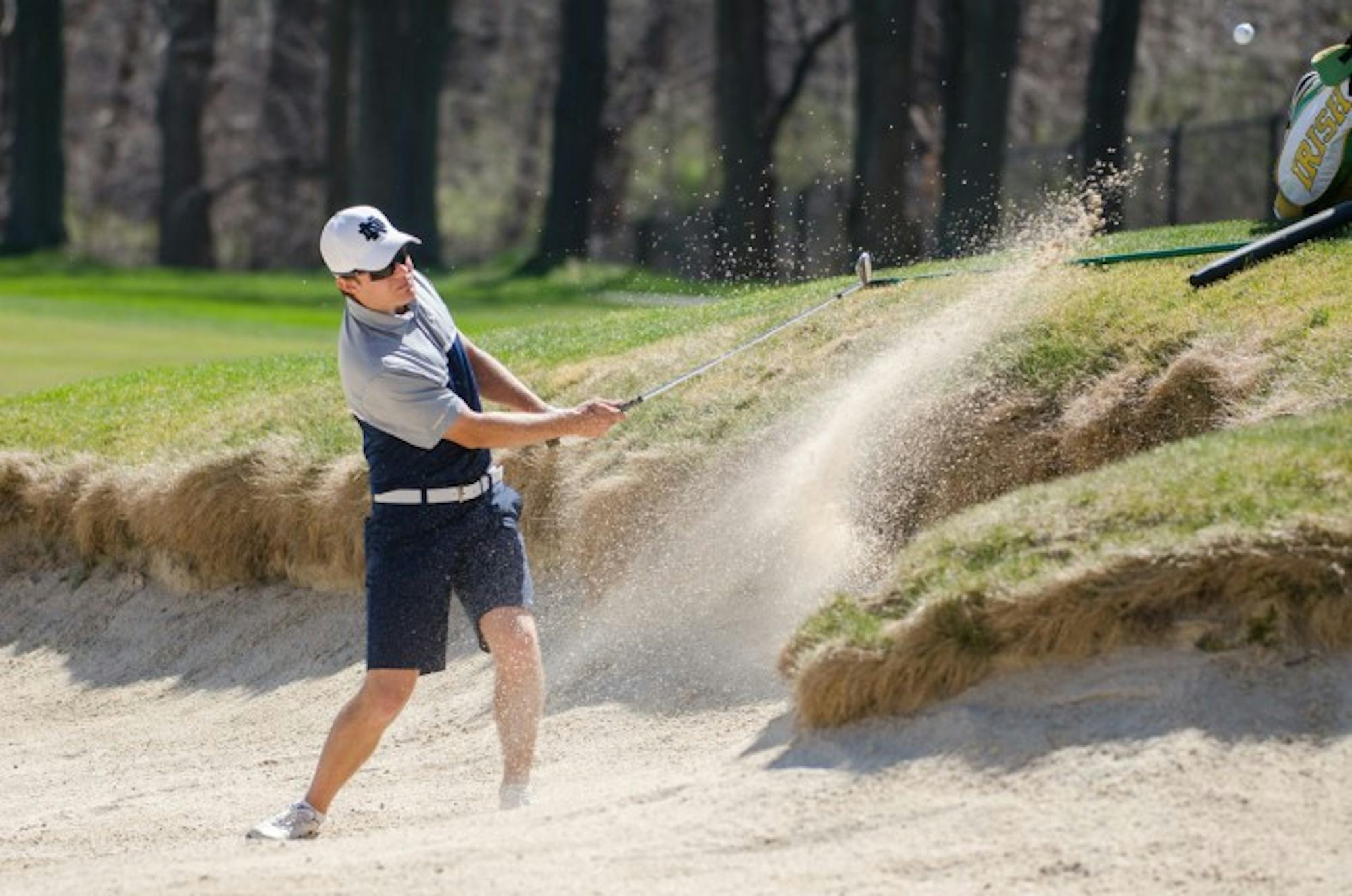 Irish sophomore Jens Verhey hits the ball out of the bunker during Notre Dame’s first place finish at the Battle at the Warren Invitational at the Warren Golf Course on April 16.
