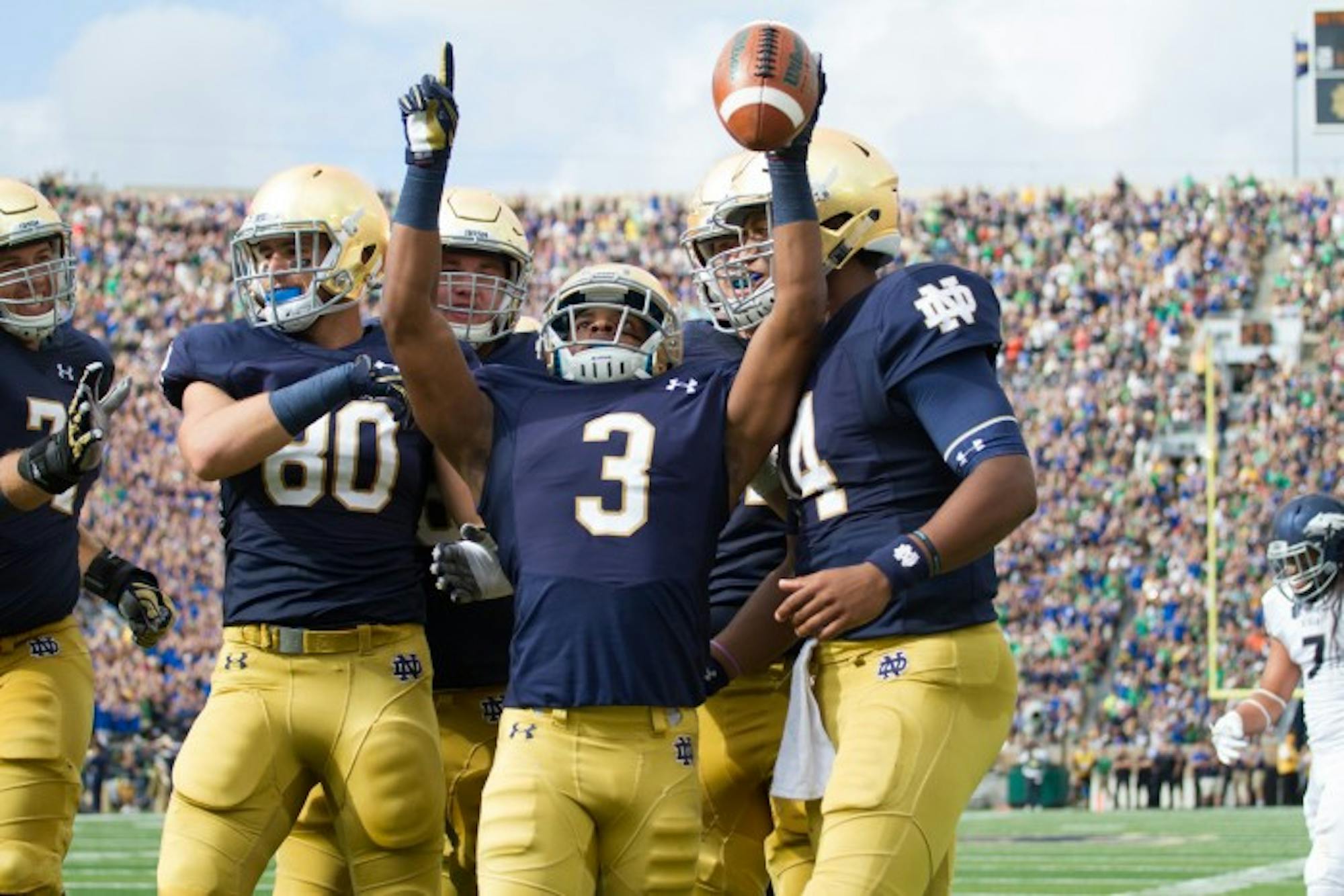 Irish sophomore receiver C.J. Sanders, center, celebrates with teammates following his touchdown Saturday in Notre Dame’s 39-10 win over Nevada.