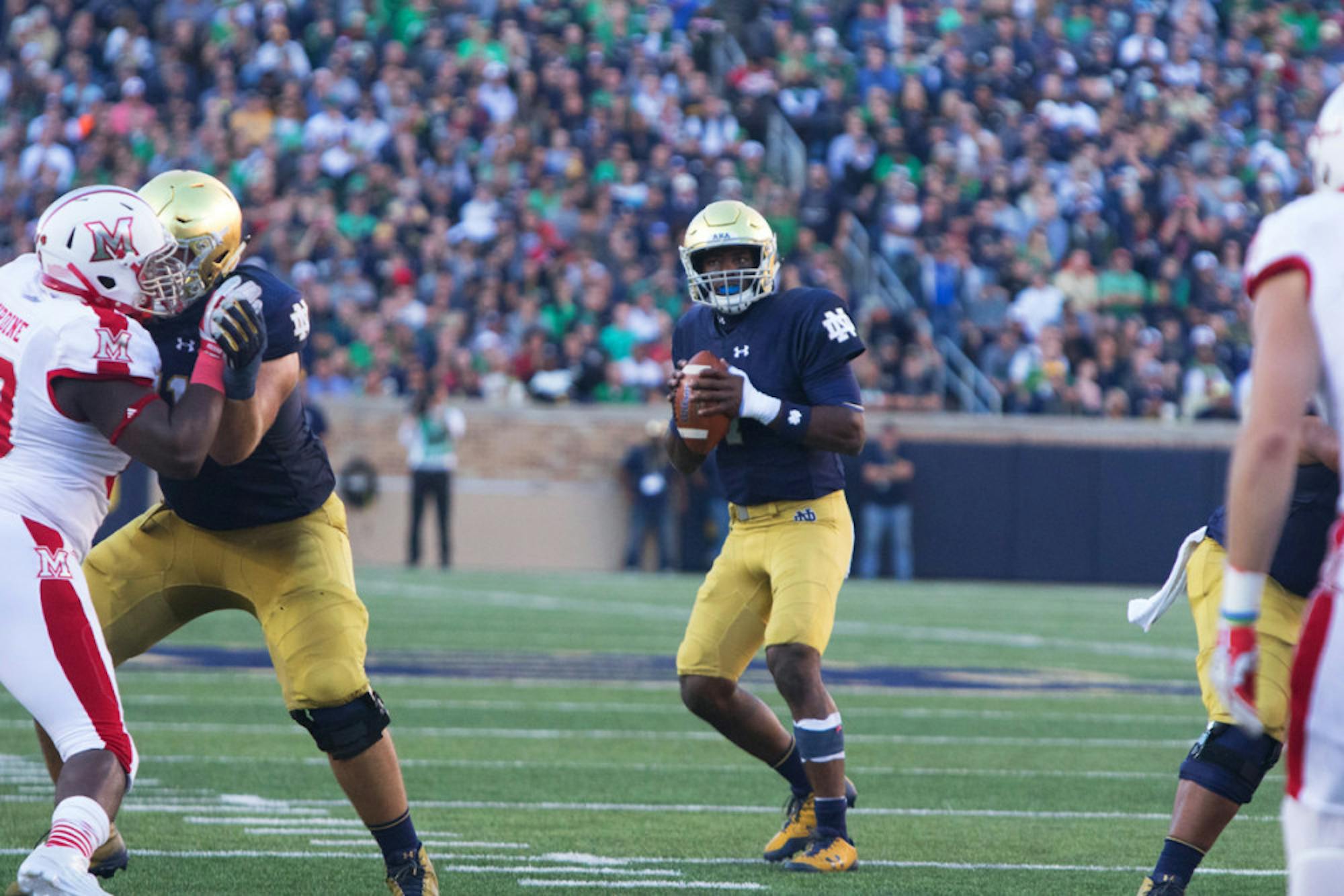 Irish junior quarterback Brandon Wimbush drops back to pass and surveys the field during Notre Dame’s 52-17 win over Miami (OH) on Saturday at Notre Dame Stadium. Wimbush passed for 119 yards.