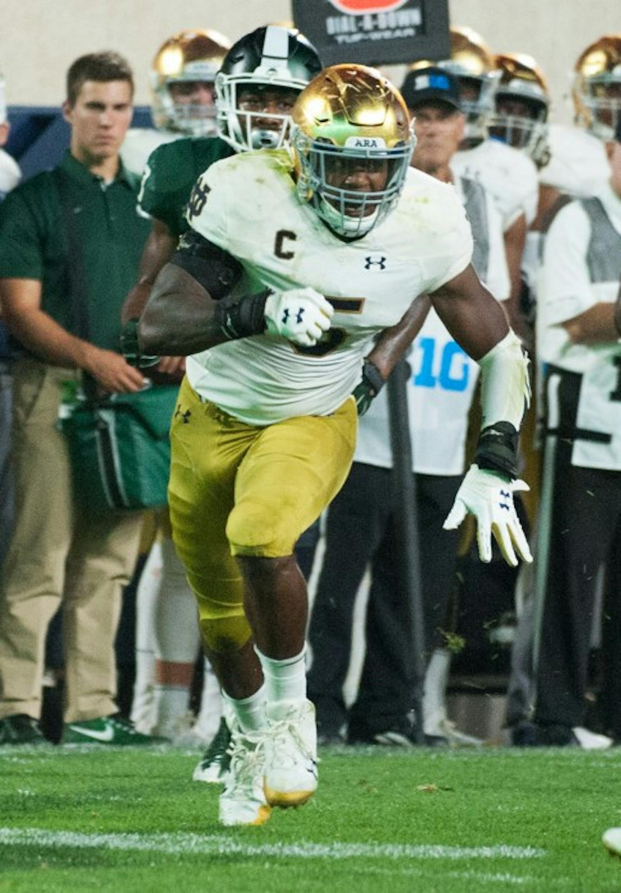 Irish captain and senior linebacker Nyles Morgan chases an opponent during Notre Dame's 38-18 victory over Michigan State on Sept. 23 at Spartan Stadium.