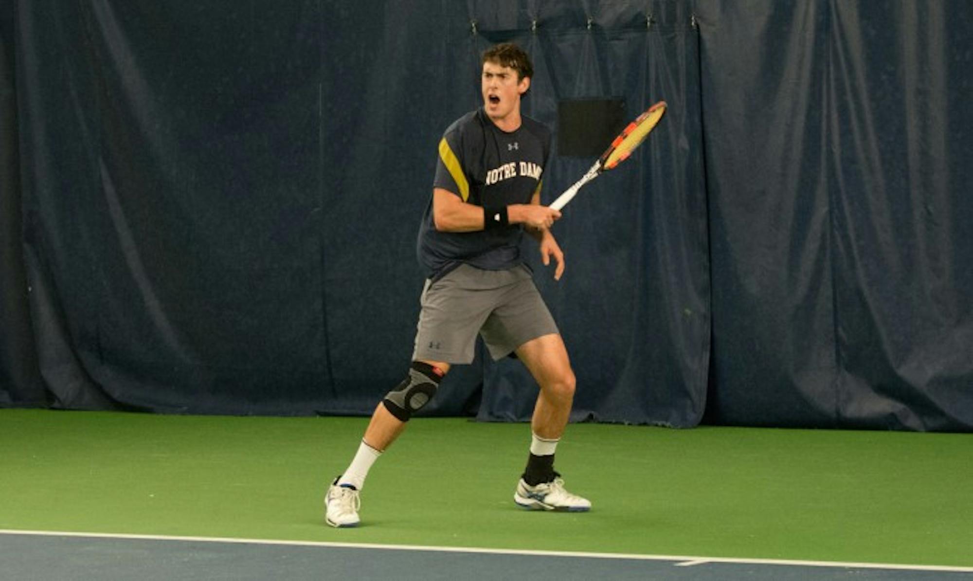 Irish junior Alex Lebedev reacts after scoring a point during a match against Northwestern on Feb. 24 at Eck Tennis Pavilion.