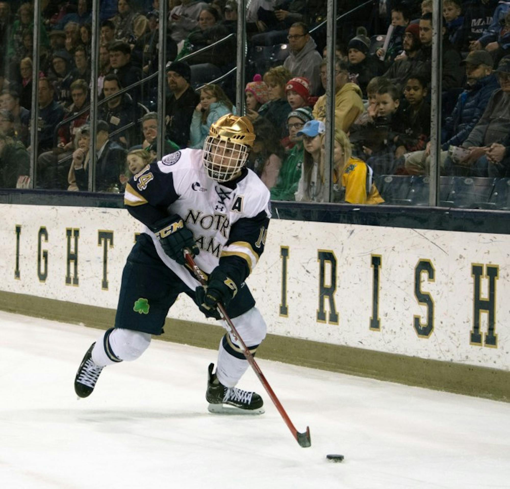 Irish senior center Thomas DiPauli skates down the ice with the puck during Notre Dame’s 5-1 victory over Maine on Saturday at Compton Family Ice Arena. DiPauli recorded an assist in the second period.