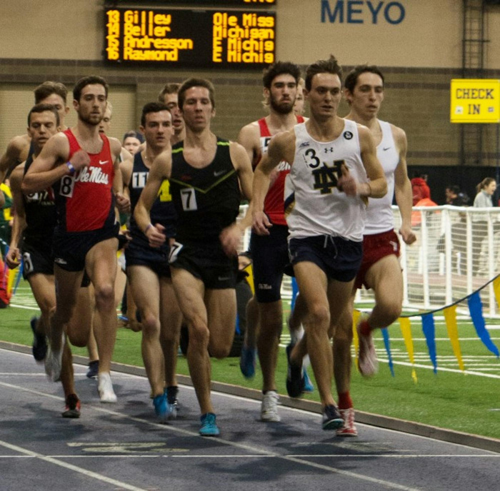 Senior Michael Clevenger leads a pack of runners during the 3,000-meter run at Loftus Sports Center on Saturday afternoon. Clevenger finished the event with a time of 18:15.56.
