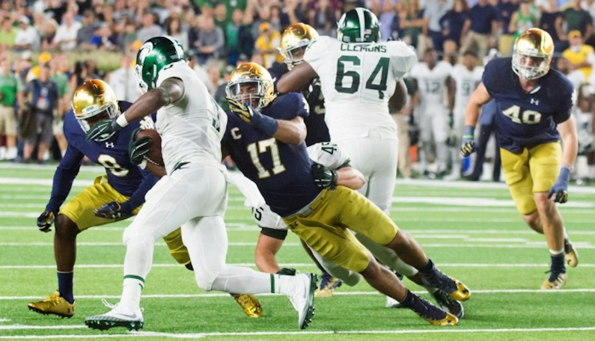 Senior linebacker James Onwaulu tackles the ball carrier during Notre Dame's 36-28 loss to Michigan State on Saturday.