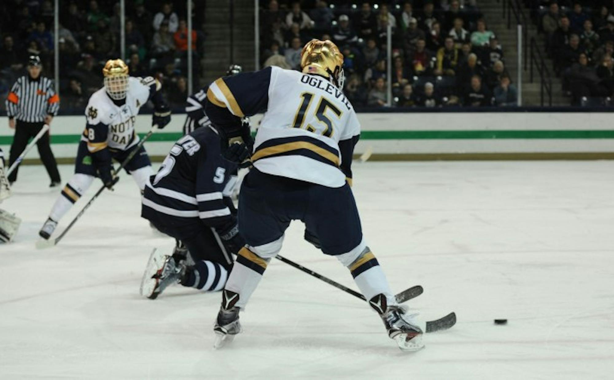 Irish sophomore forward Andrew Oglevie fights for control of the puck during Notre Dame’s 2-2 tie with New Hampshire on Jan. 20.