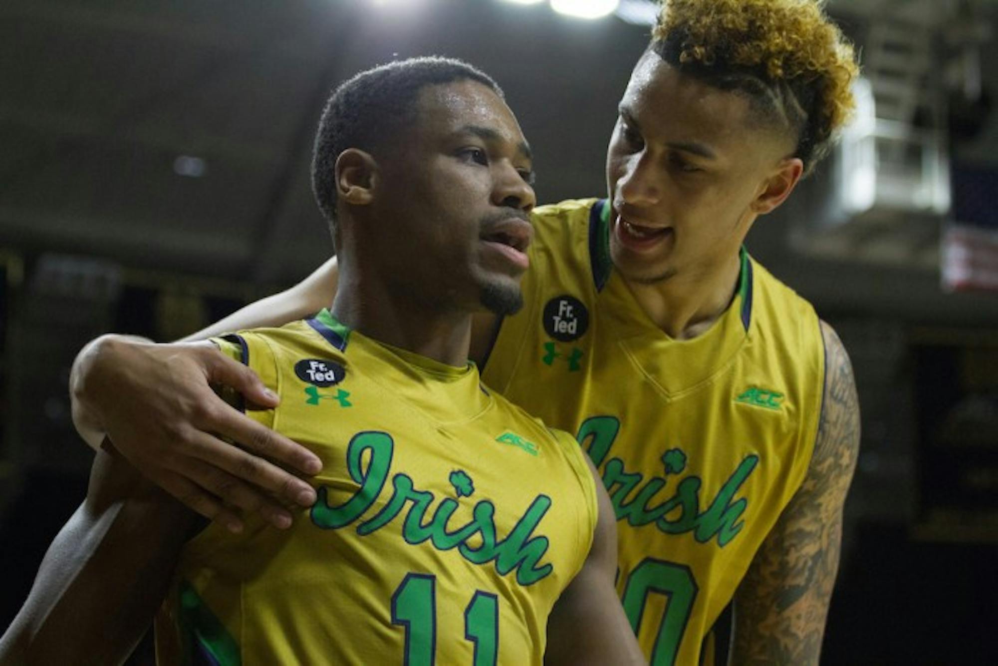 Irish junior guard Demetrius Jackson, left, and senior forward Zach Auguste talk following a play in Notre Dame’s 80-76 win over No. 2 North Carolina on Saturday night at Purcell Pavilion.