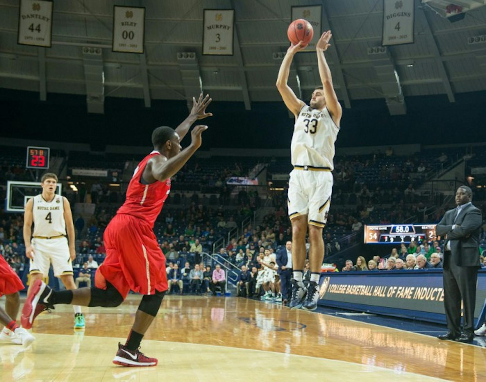 Irish freshman forward John Mooney shoots a three-pointer over the defender during a game against Seattle on Nov. 16.
