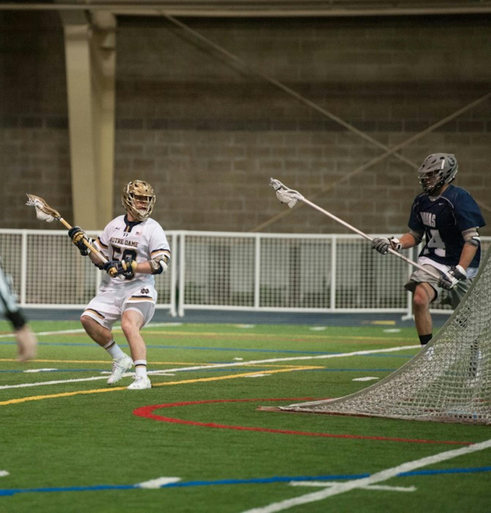 Junior attack Matt Kavanagh looks to pass in Notre Dame’s 14-12 win against Georgetown on Feb. 14 at Loftus Sports Center.