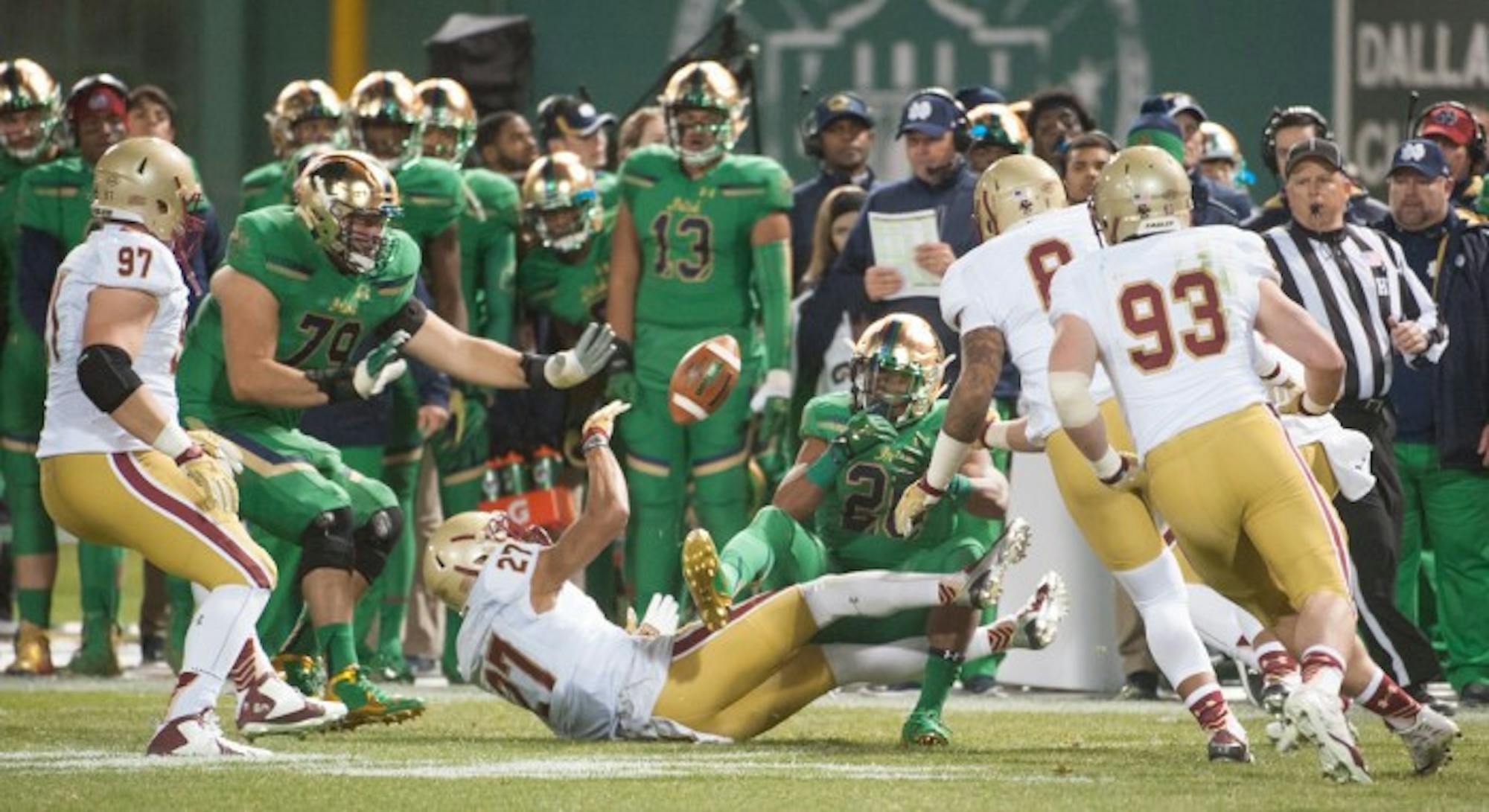 Irish senior running back C.J. Prosise, 20, loses control of the football during Notre Dame’s 19-16 win over Boston College on Saturday at Fenway Park in Boston. The Eagles  recovered the fumble, one of Notre Dame’s five turnovers in the game. Prosise left the game in the second quarter due to a high ankle sprain after running for 54 yards on nine carries.