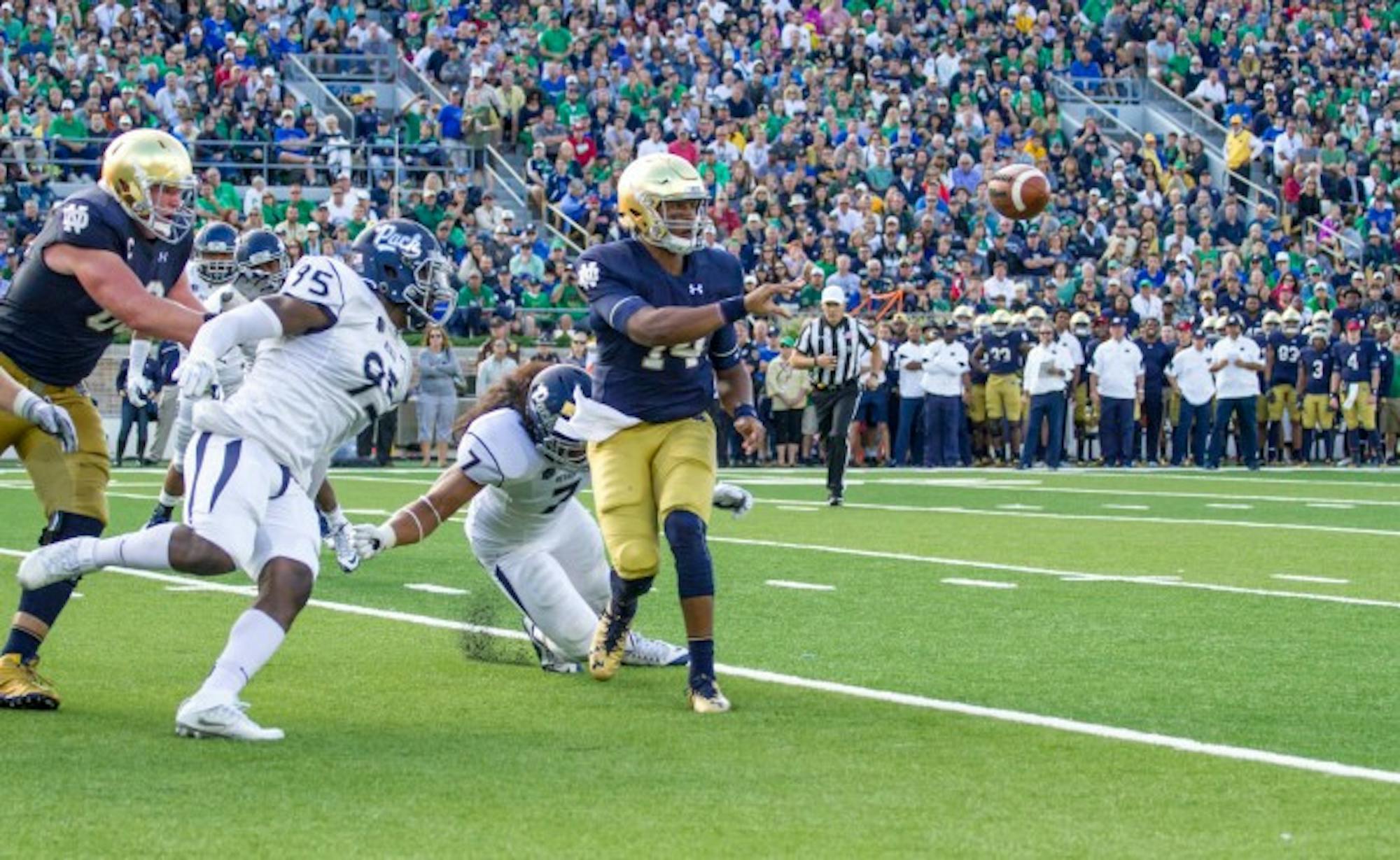 Junior quarterback DeShone Kizer pitches the ball to senior running back Tarean Folston for a touchdown during Notre Dame’s 39-10 win over Nevada on Saturday.