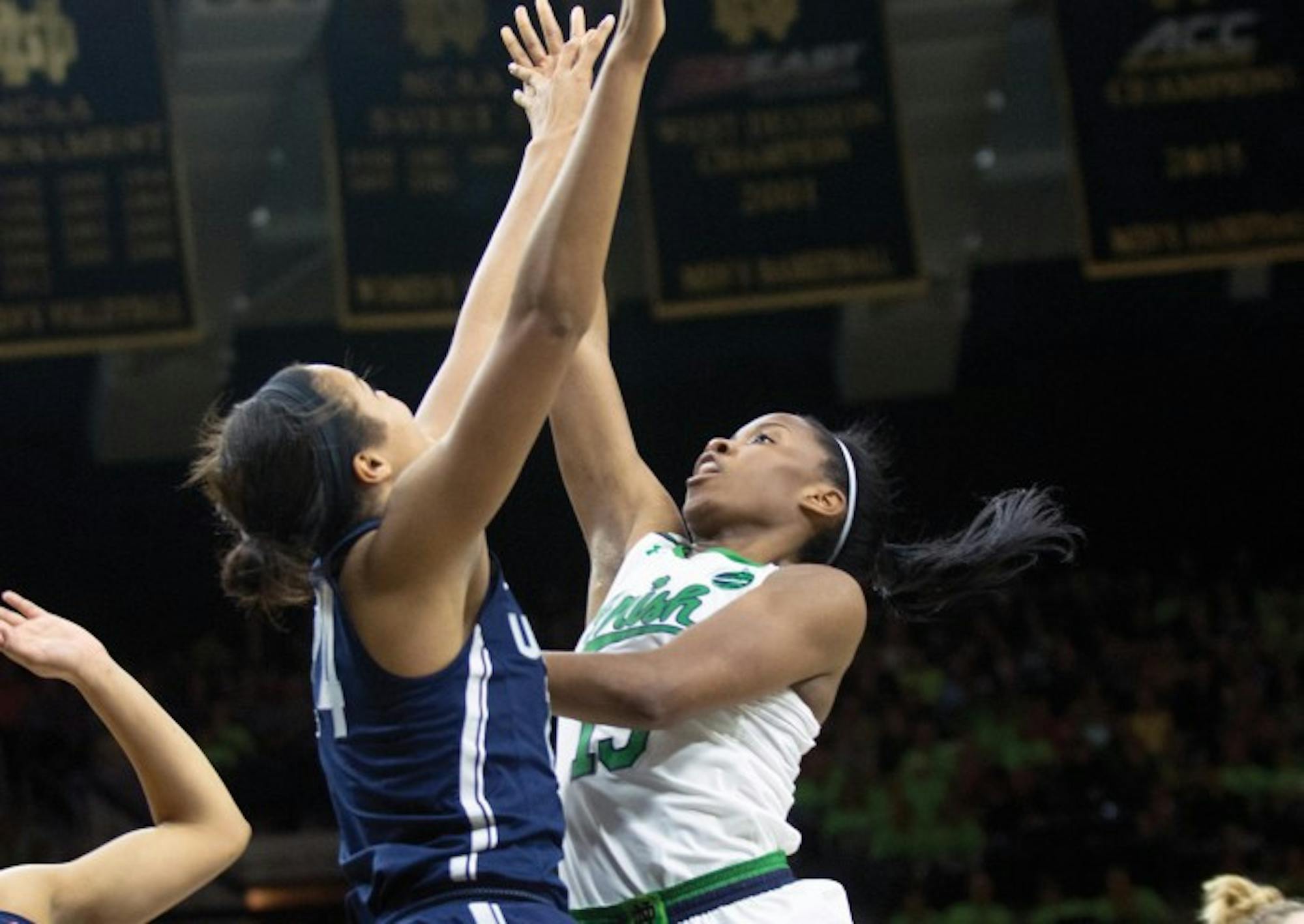 Irish senior guard Lindsay Allen floats the ball over a Huskies defender during Notre Dame’s 72-61 loss to UConn on Dec. 7 at Purcell Pavilion.