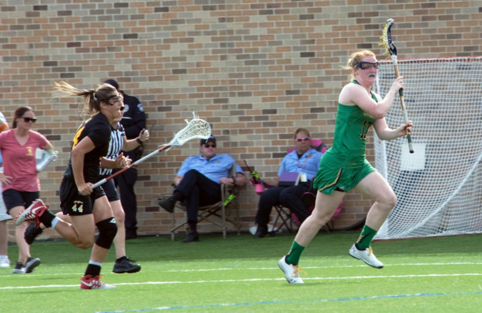 Irish graduate student defender Barbara Sullivan carries the ball upfield during Notre Dame’s 5-4 loss to USC on April 18.