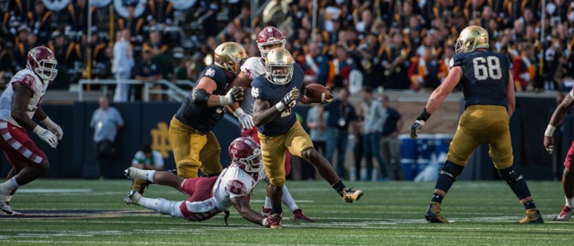 Irish junior running back Dexter Williams slips a tackle and heads upfield during Notre Dame's 49-16 win over Temple on Sunday. Williams tallied 124 yards and a touchdown on six carries in the Irish victory.