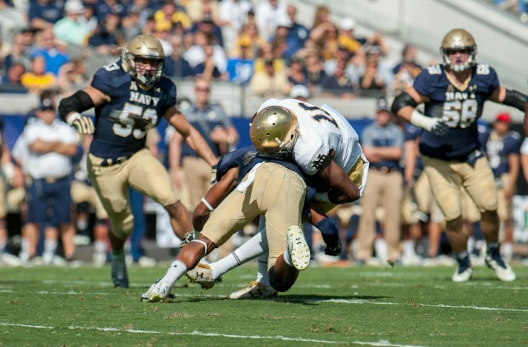 Irish senior receiver Torii Hunter Jr. takes a hit form a Navy defender during Notre Dame's 28-27 loss to the Midshipmen. Hunter Jr. had 104 yards receiving and one touchdown in the contest.
