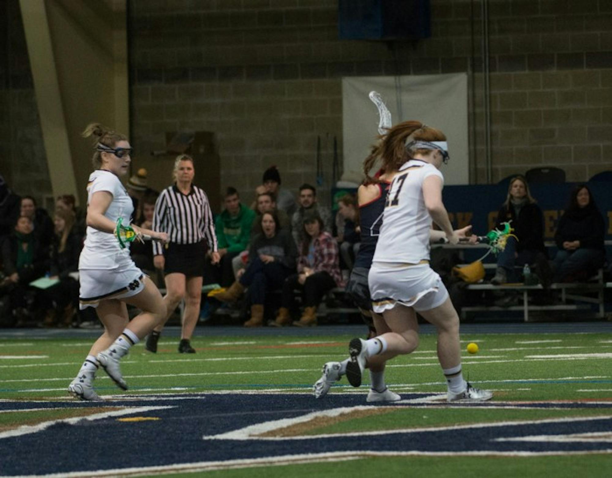 Irish senior defender Barbara Sullivan, right, chases after a ground ball during Notre Dame’s 17-5 win over Detroit on Sunday at Loftus Sports Center. Sullivan is this year’s team captain.