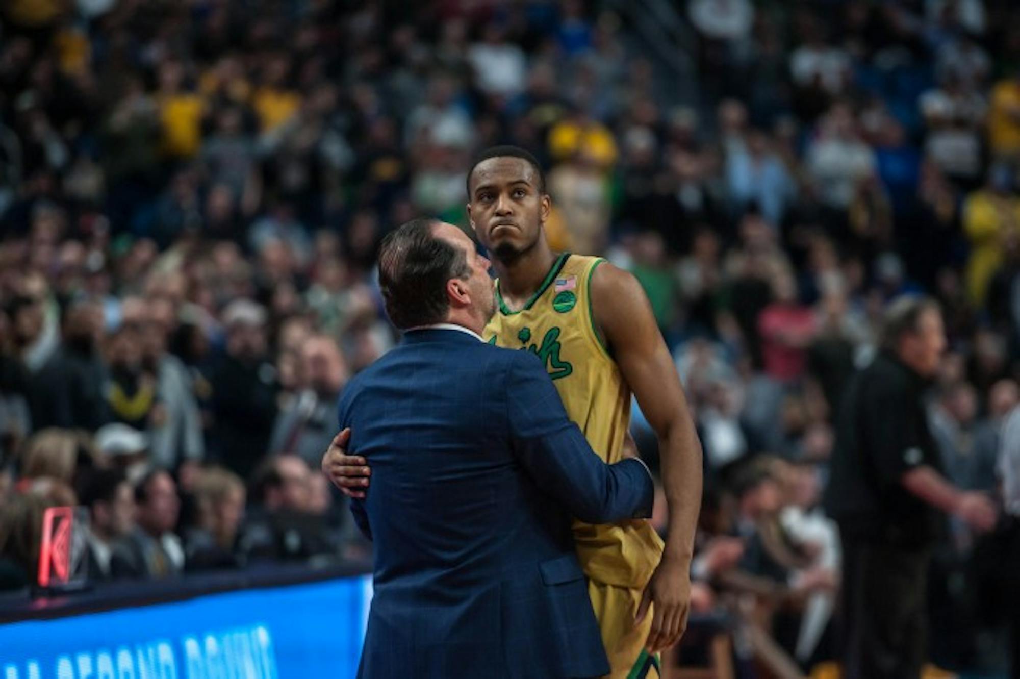 Irish senior forward V.J. Beachem hugs head coach Mike Brey in the final minutes of Notre Dame’s 83-71 loss to West Virginia on Saturday at KeyBank Arena.
