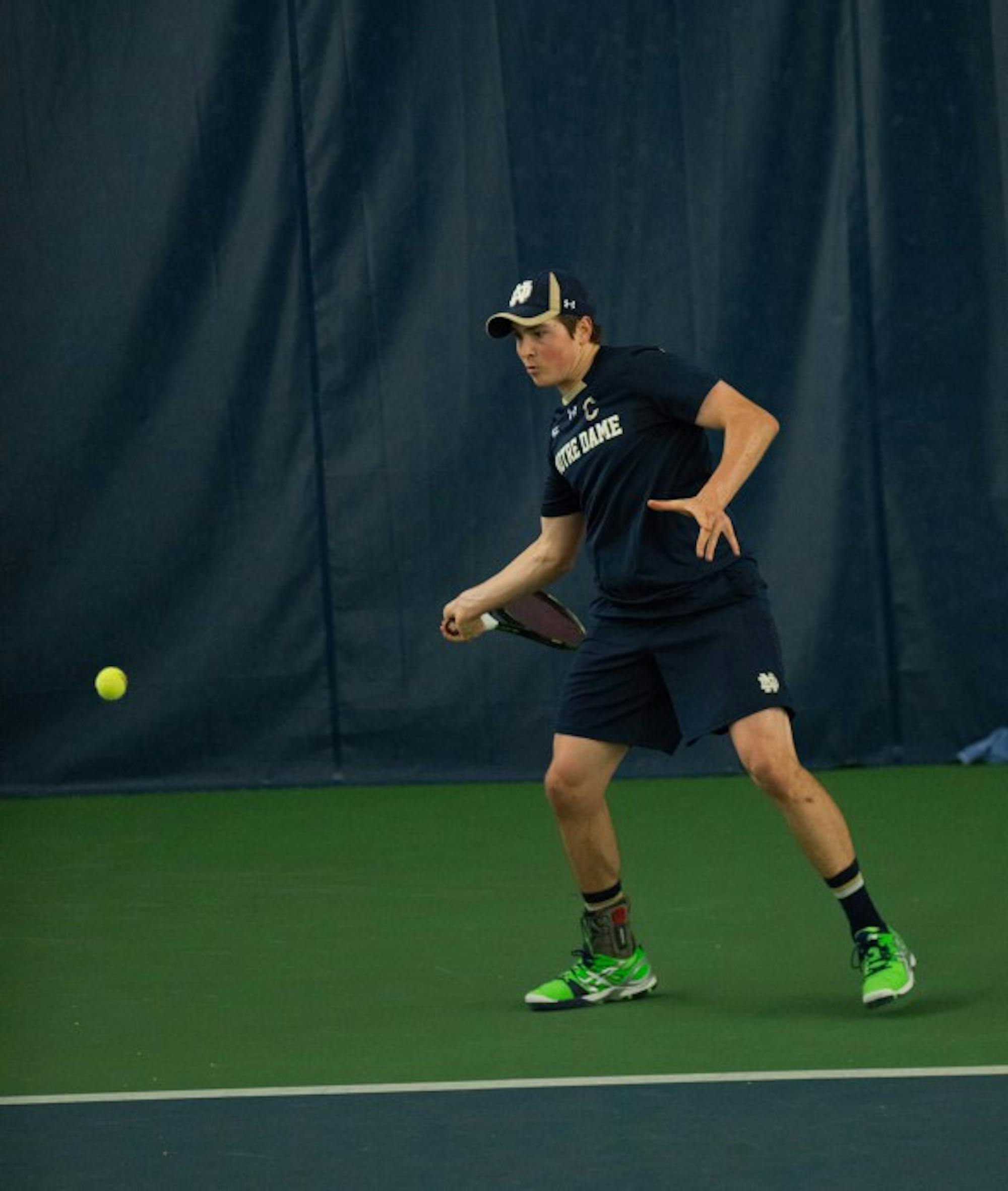 Irish junior captain Eric Schnurrenberger swings at the ball during his Jan. 24 match against Oklahoma State at Eck Tennis Pavilion.