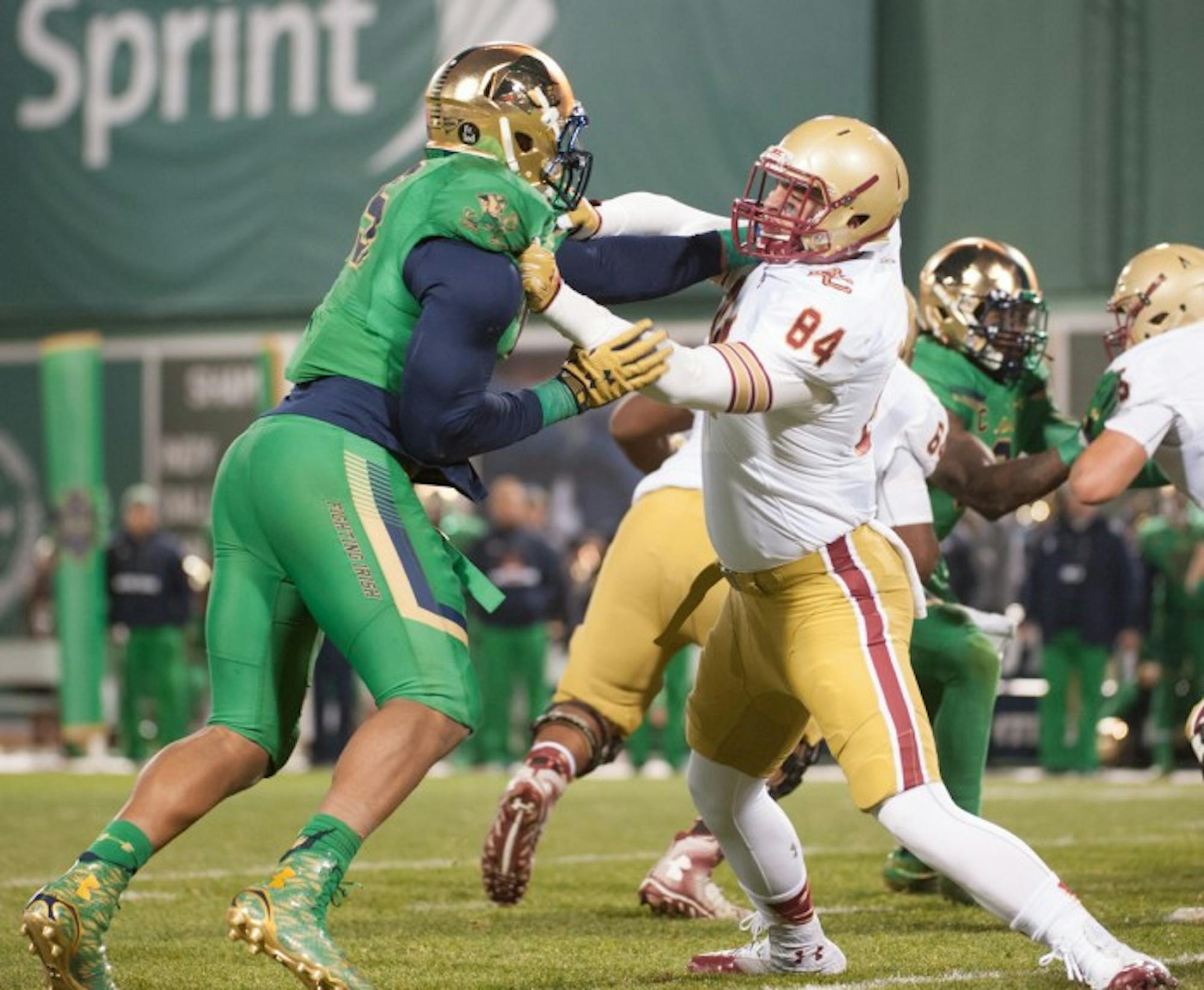 Senior defenselineman Romeo Okwara holds off a Boston College player during Notre Dame’s 19-13 victory at Fenway Park.