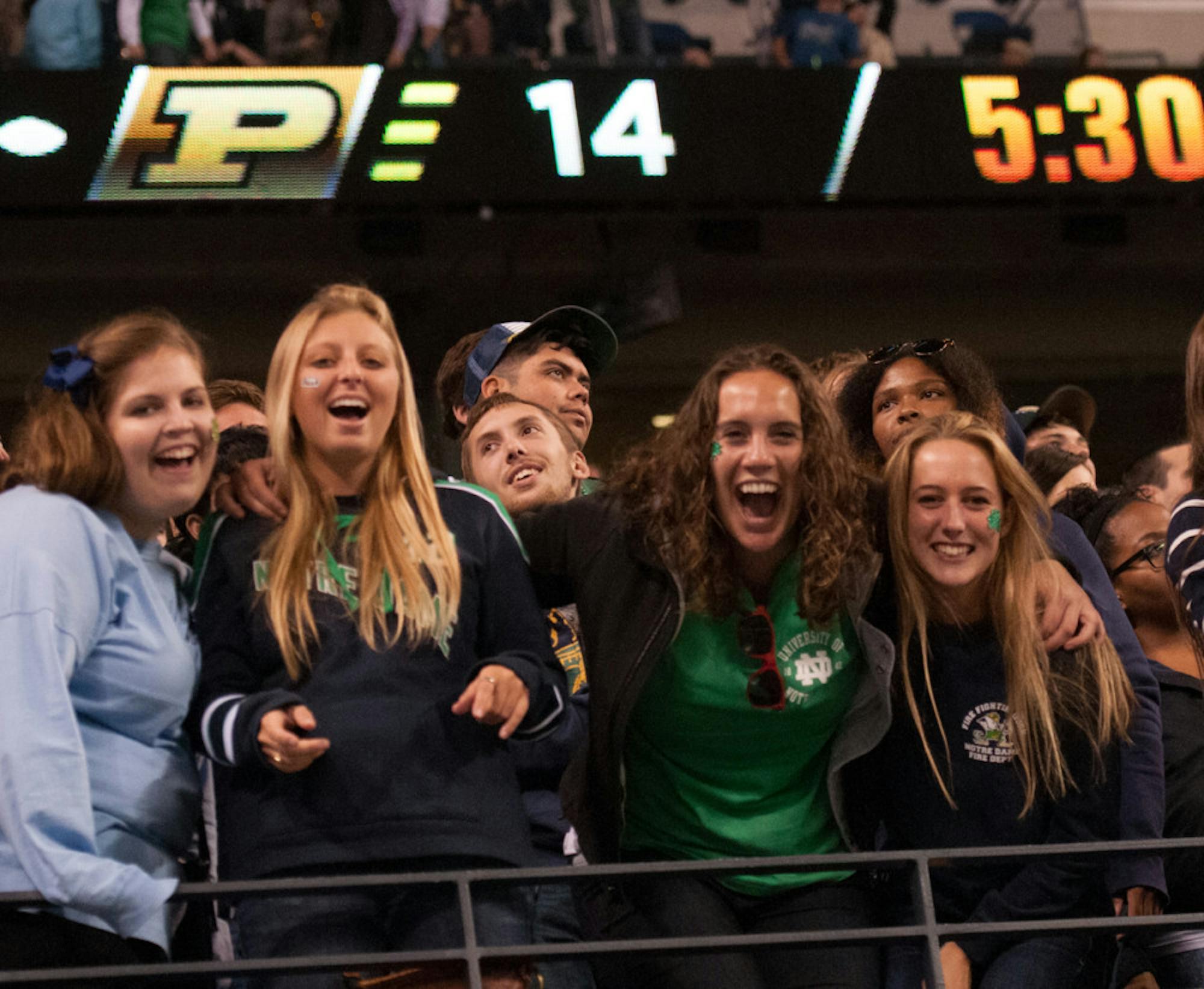 A group of students cheer on the Irish against Purdue in the Shamrock series in Lucas Oil Stadium on Sept. 13, 2014.