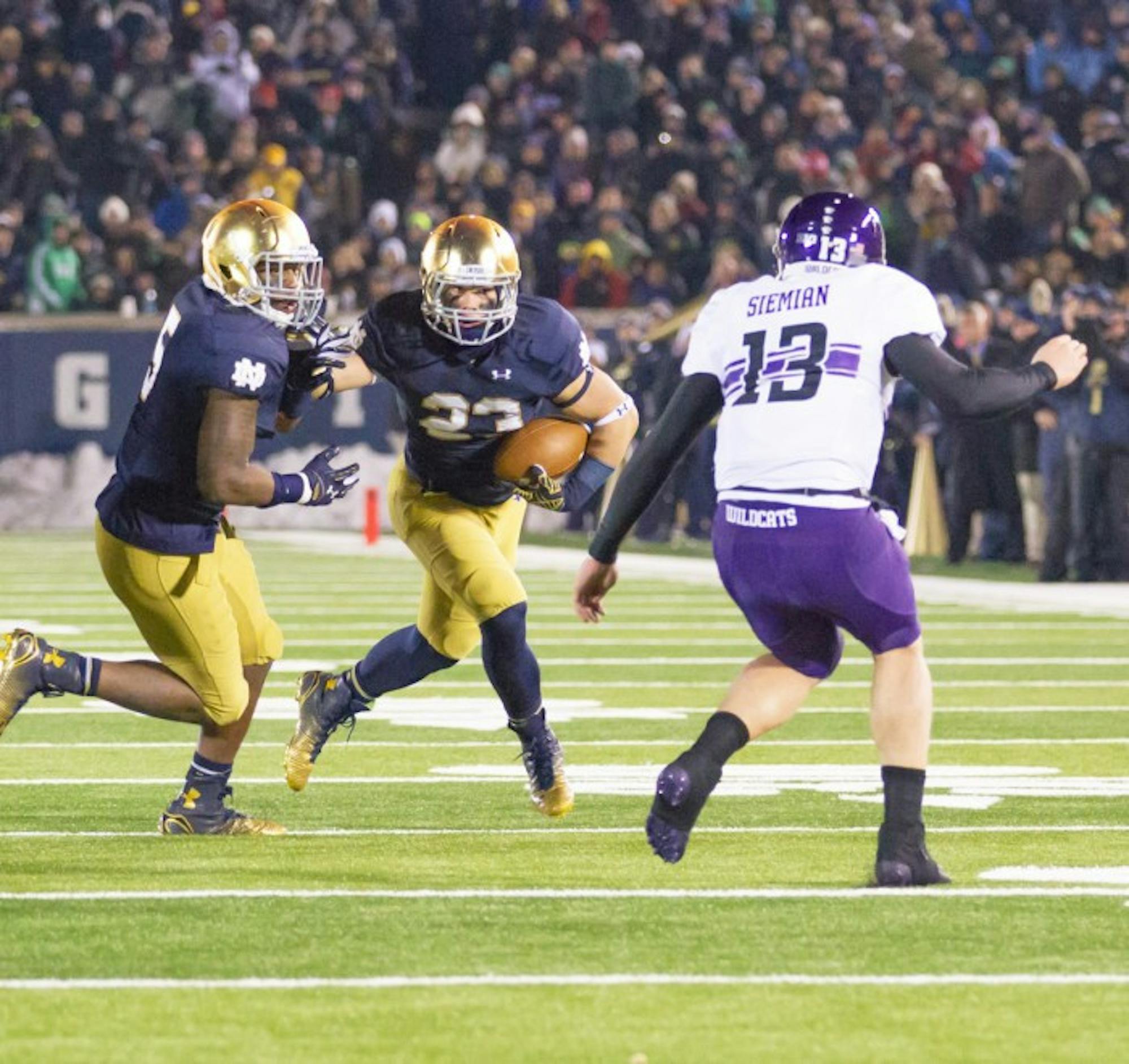 Irish freshman safety Drue Tranquill heads upfield after recovering a fumble Saturday against Northwestern at Notre Dame Stadium.