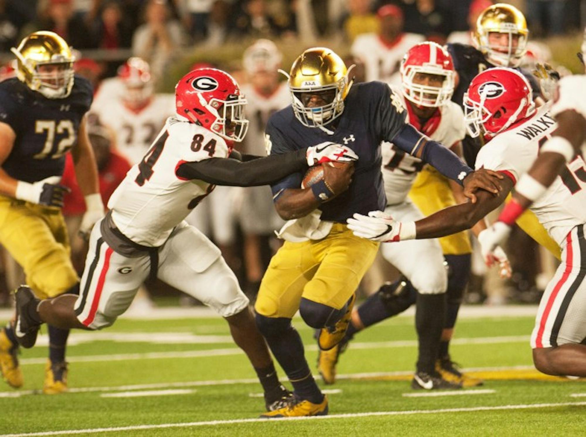 Irish junior quarterback Brandon Wimbush tries to fight his way through two Georgia defenders during Notre Dame's 20-19 loss to the Bulldogs on Saturday. Wimbush rushed 16 times for only one yard.