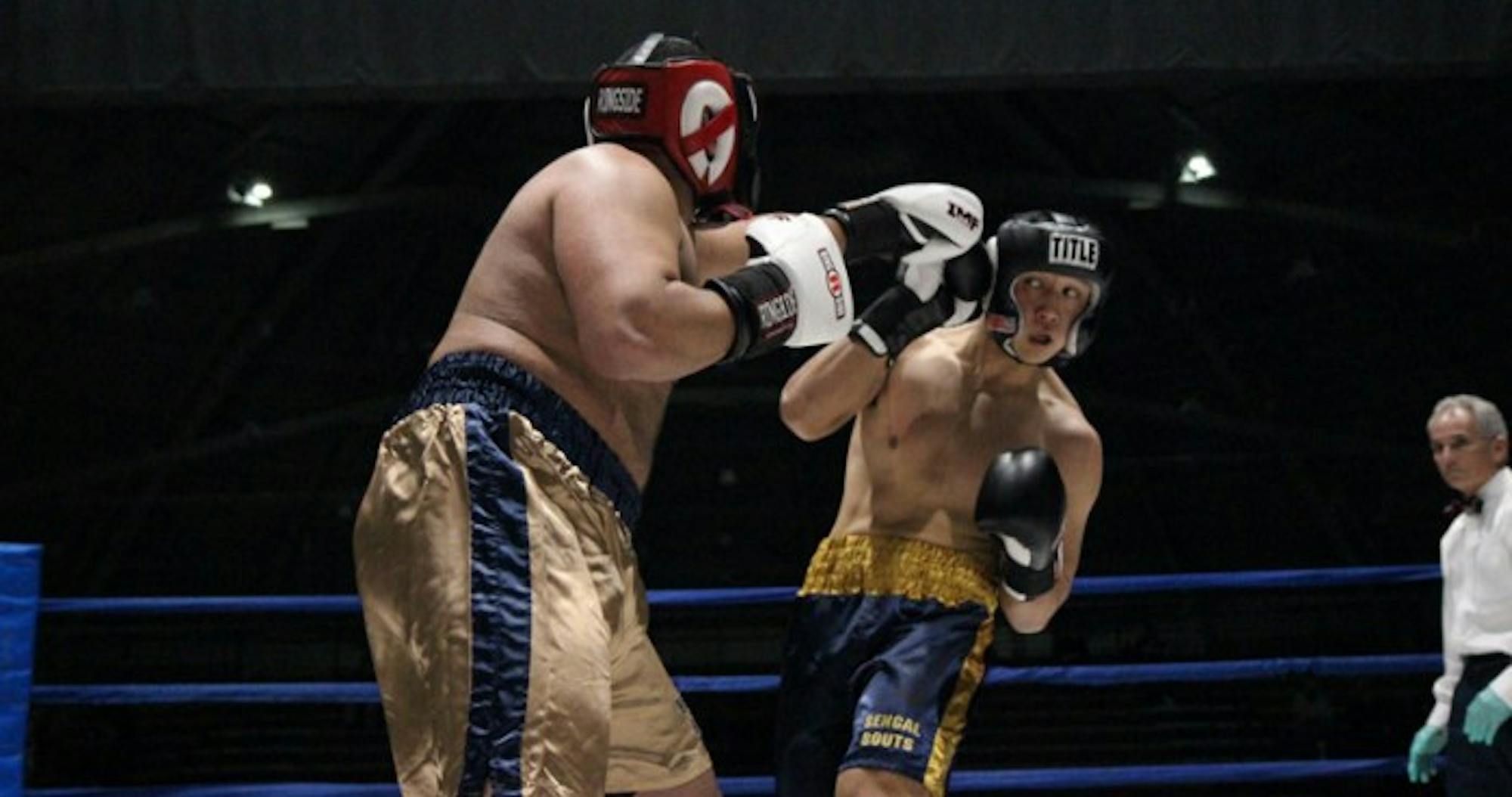 Senior captain and club president Daniel Yi, right, dodges a punch from law student Brian Israel during his victory by unanimous decision in the semifinals on Tuesday. Yi has won three straight Bengal Bouts titles and will go for a historic fourth on Sunday against freshman Erich Jegier.