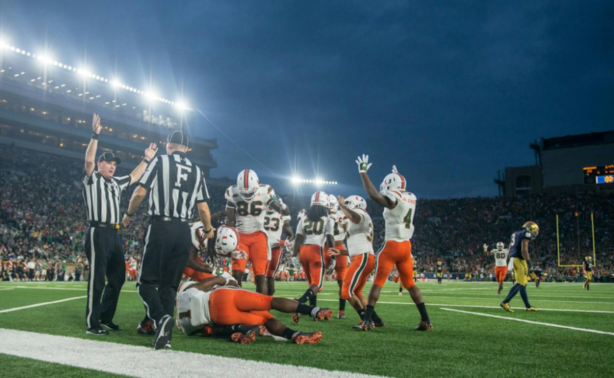 The Miami punt coverage unit celebrates scoring a go-ahead touchdown after Irish sophomore receiver C.J. Sanders, right, muffed a punt that rolled into the end zone. The recovery put the Hurricanes up 27-20.