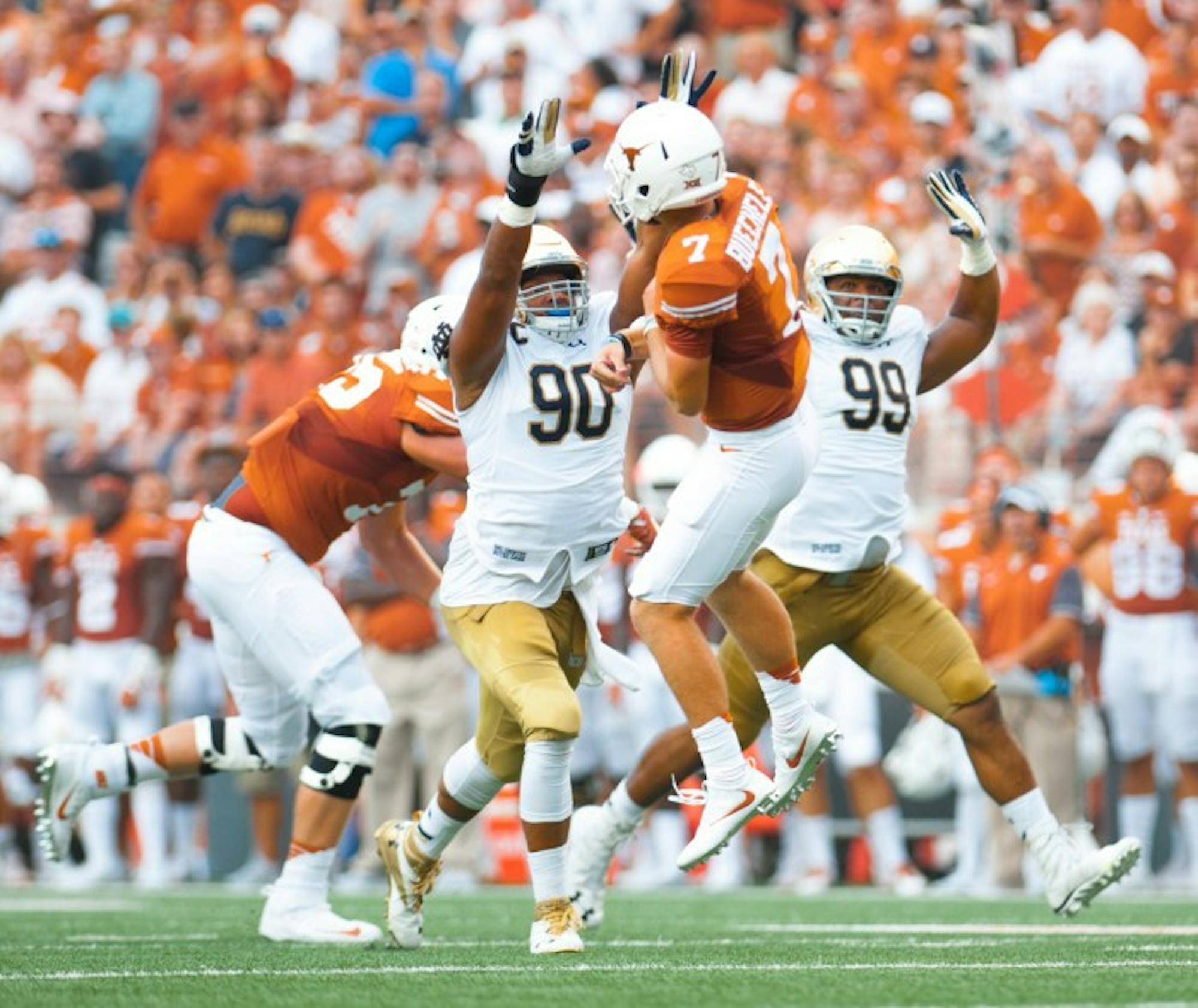Irish senior Isaac Rochell, left, and sophomore Jerry Tillery, right, attempt to deflect a pass during Notre Dame’s 50-47 loss to Texas.