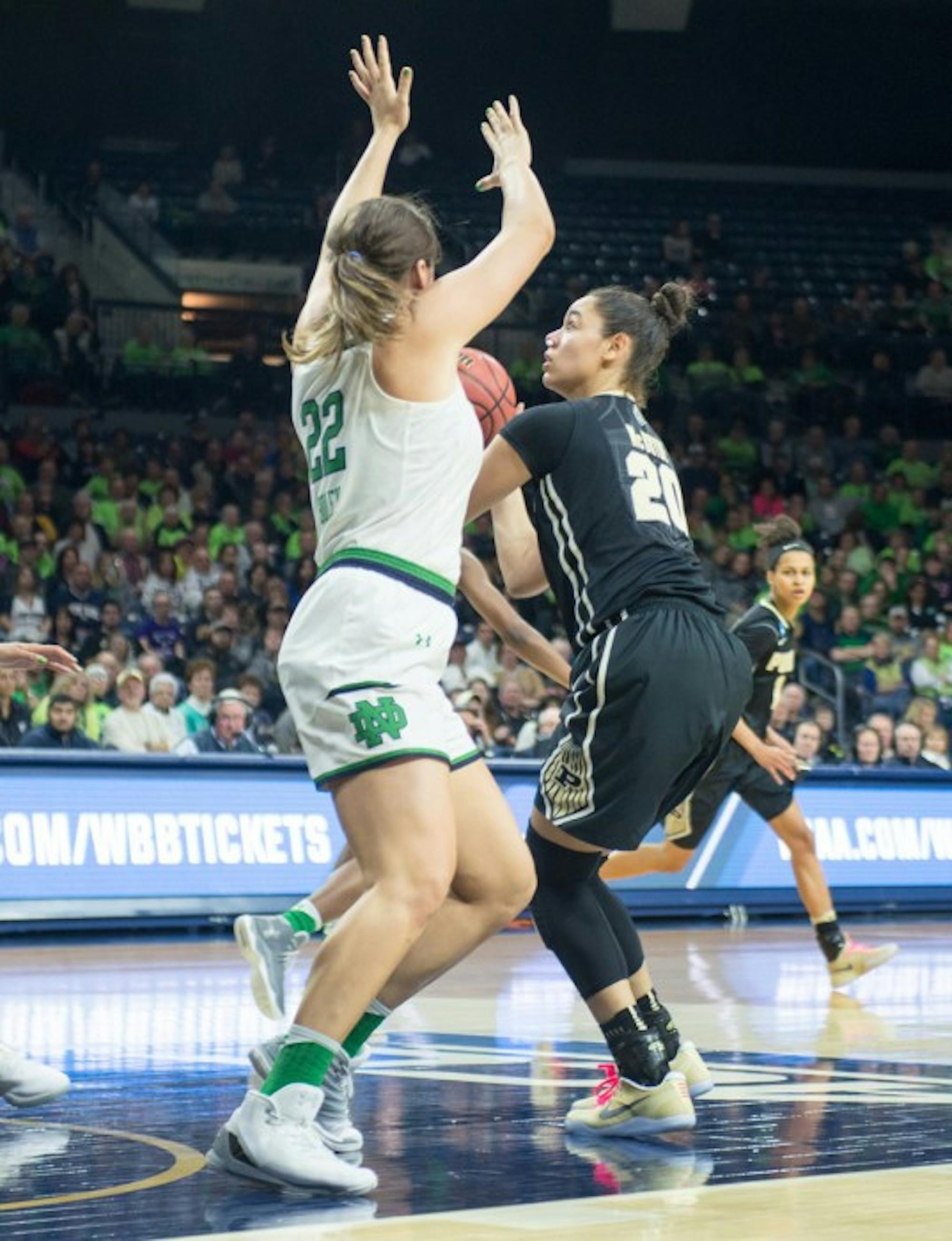 Former forward Erin Boley defends the paint against Boilermakers sophomore forward Dominique McBryde during Notre Dame’s 88-82 overtime win over Purdue on March 19 at Purcell Pavilion. Boley announced Tuesday that she would be transferring to Oregon for the remainder of her collegiate career.