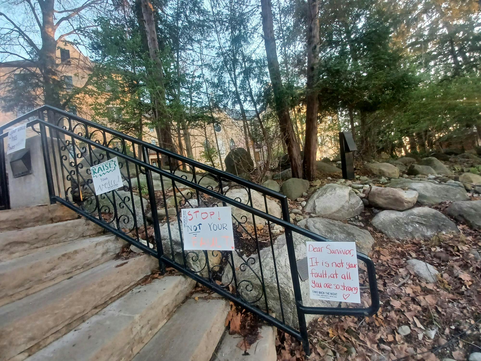 Signs in support of sexual violence survivors at the Grotto