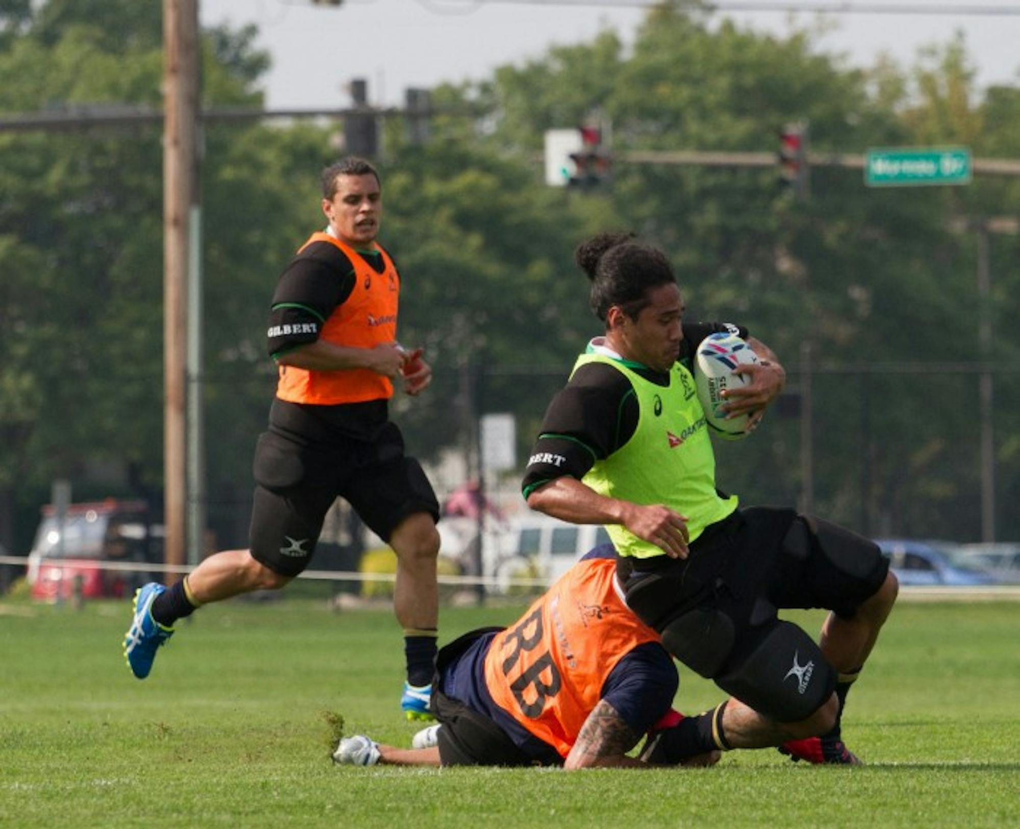 Wallabies winger Joe Tomane slides after being taken down in a practice Sept. 1 at Stinson Rugby Field.