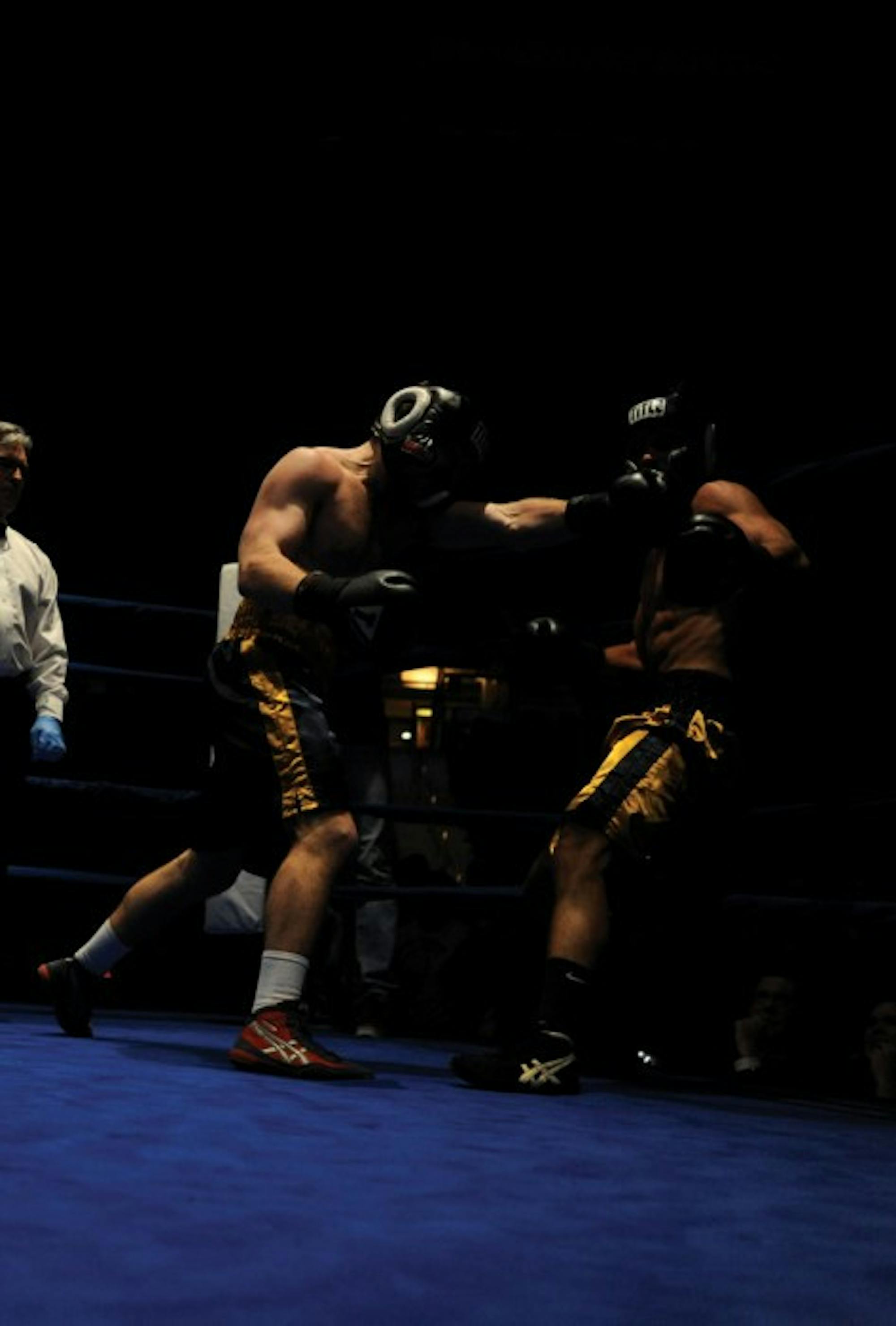Former Irish boxer and captain Ryan Alberdi, left, lands a left hook in last year’s 185-pound final. Alberdi now coaches young boxers.