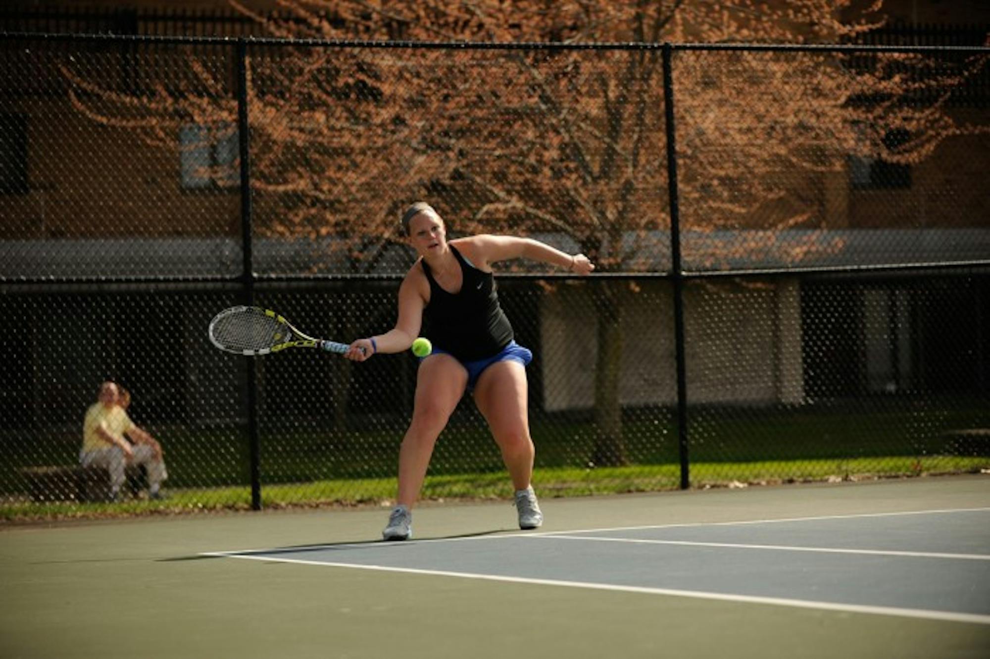 Belles sophomore Sam Setterblad returns a serve during Saint Mary’s 8-1 win over Adrian on April 14 at Saint Mary’s Tennis Courts.