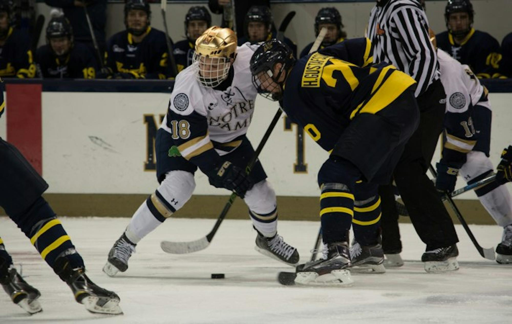 Irish sophomore center Jake Evans fights for a faceoff win during Notre Dame’s 7-2 win over Merrimack on Jan. 15 at Compton Family Ice Arena. Evans has registered a point in six straight games for the Irish.