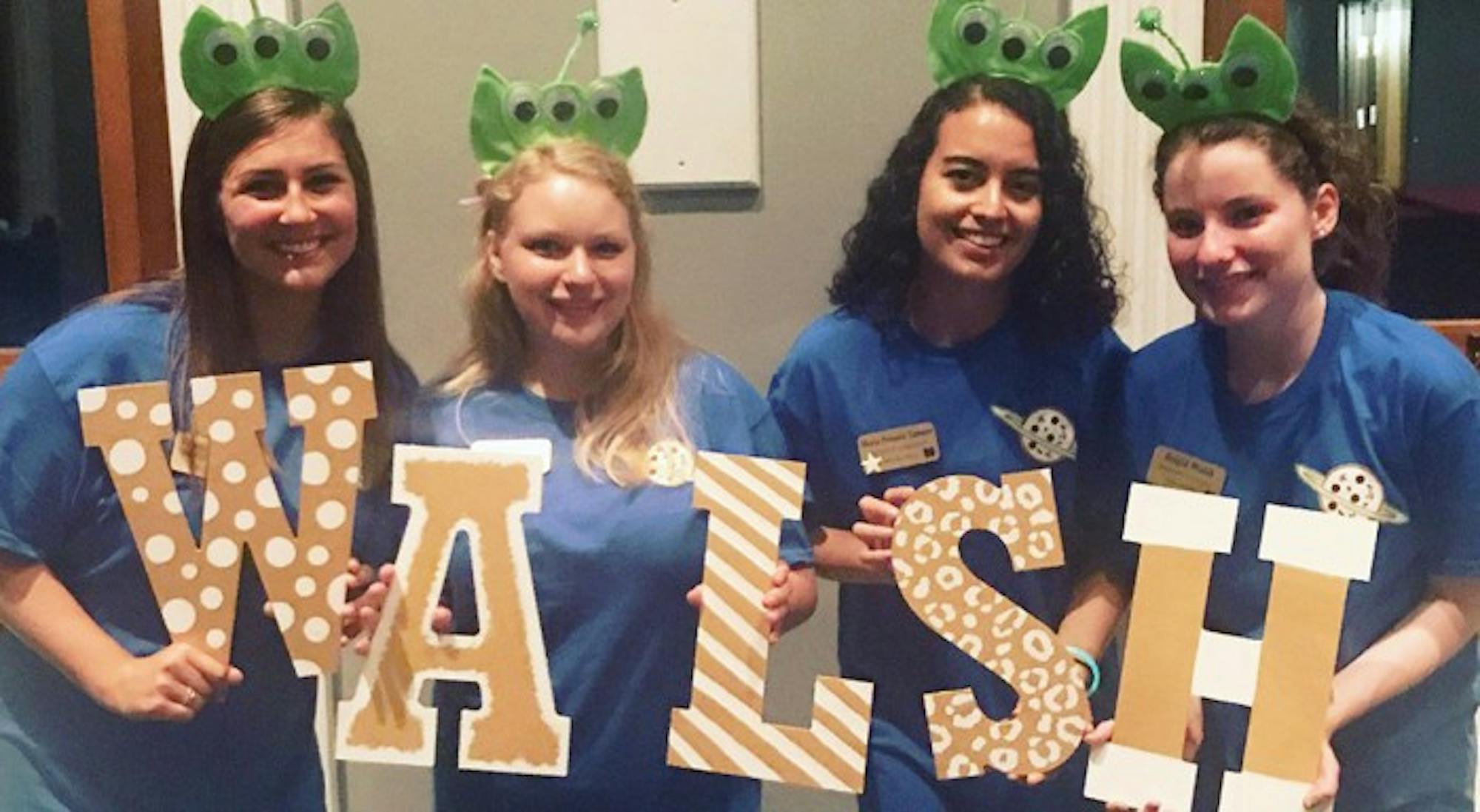 Students hold letters spelling out the name of their dorm, Walsh Hall, at Walsh Hall's