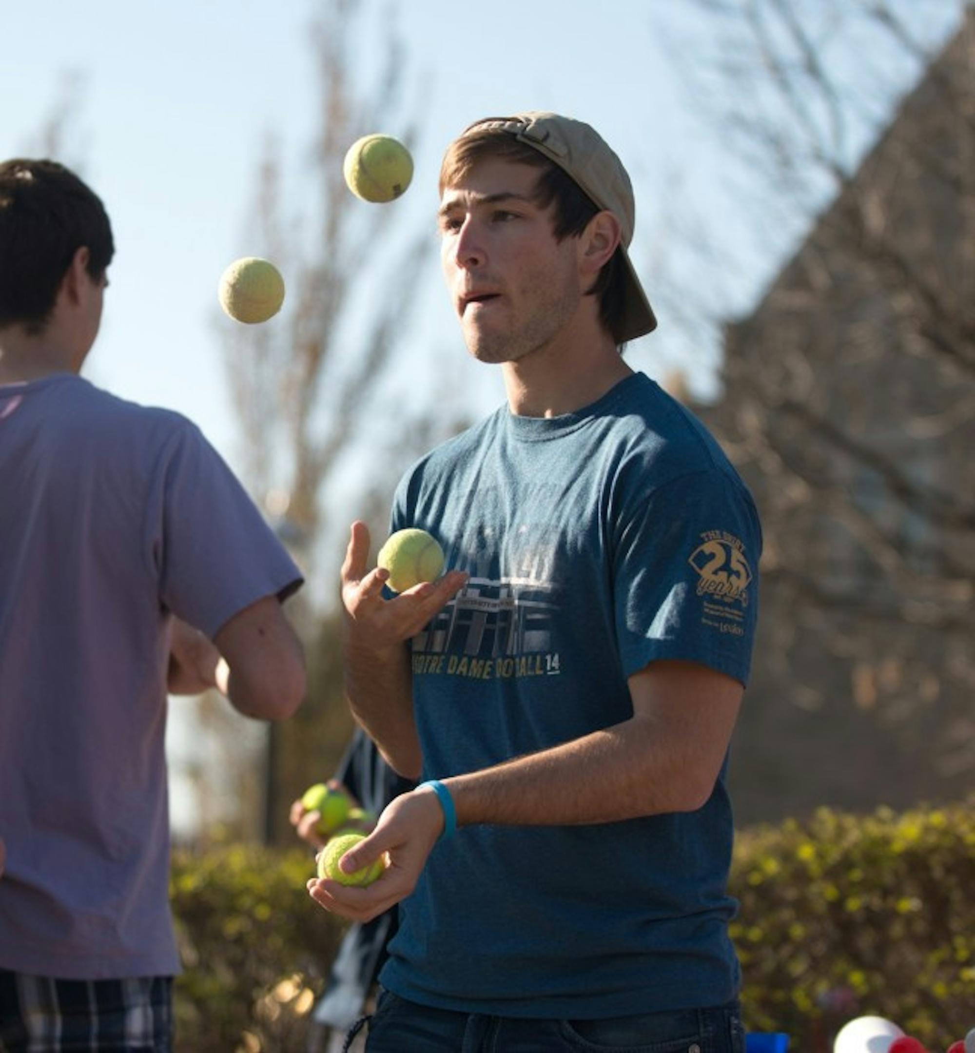 A member of the Notre Dame juggling club develops his juggling skills with tennis balls.